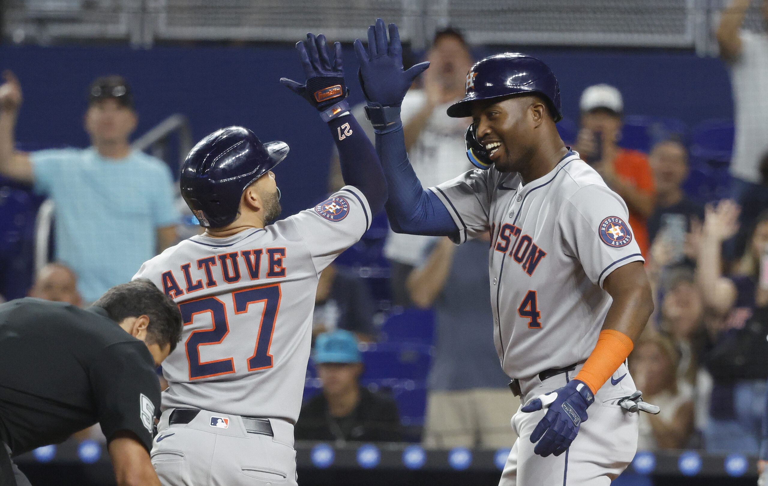 Aug 5, 2025; Miami, Florida, USA; Houston Astros outfielder Jose Altuve (27) is greeted at the plate by outfielder Jesus Sanchez (4) after his two run home run against the Miami Marlins during the first inning at loanDepot Park. Mandatory Credit: Rhona Wise-Imagn Images