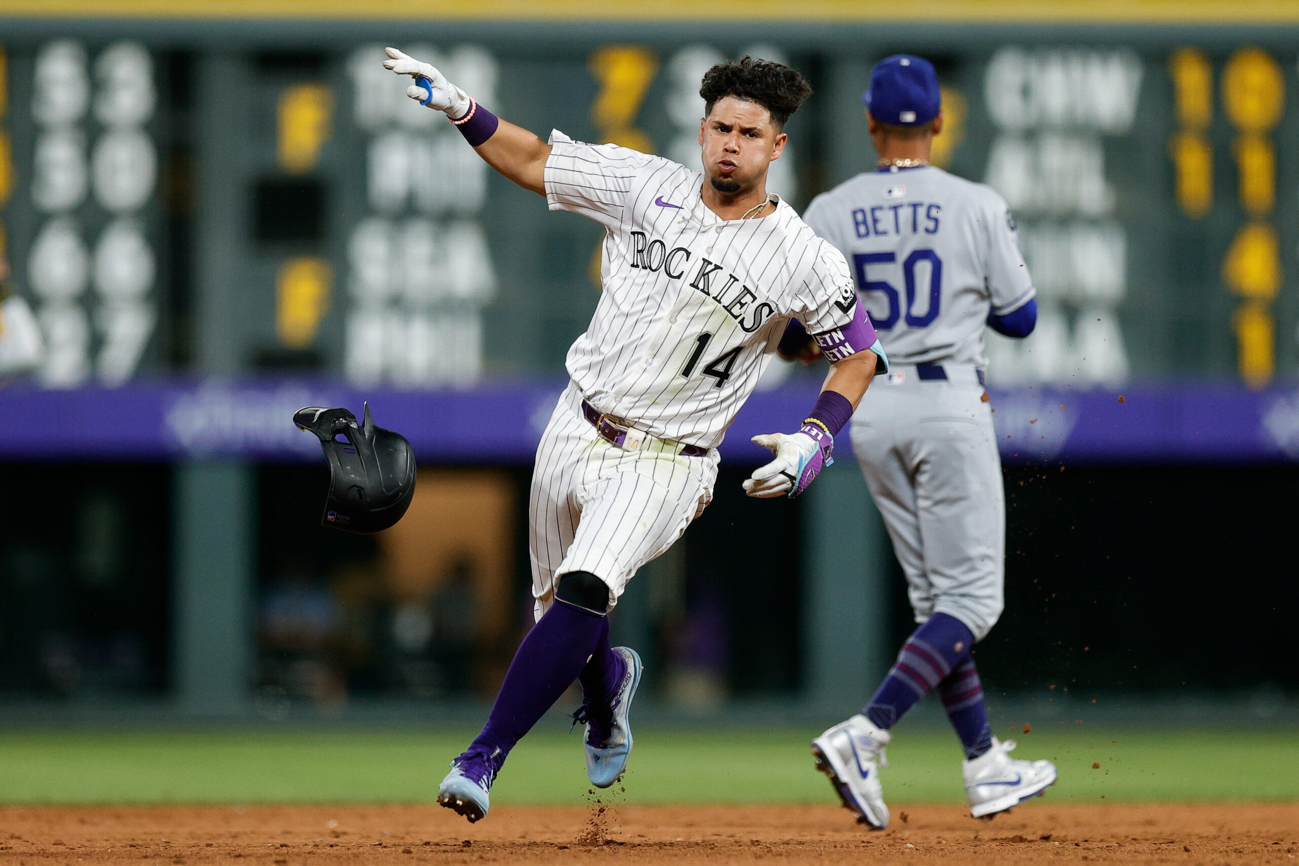 Aug 19, 2025; Denver, Colorado, USA; Colorado Rockies shortstop Ezequiel Tovar (14) rounds the bases on a triple in the eighth inning aLos Angeles Dodgers at Coors Field. Mandatory Credit: Isaiah J. Downing-Imagn Images