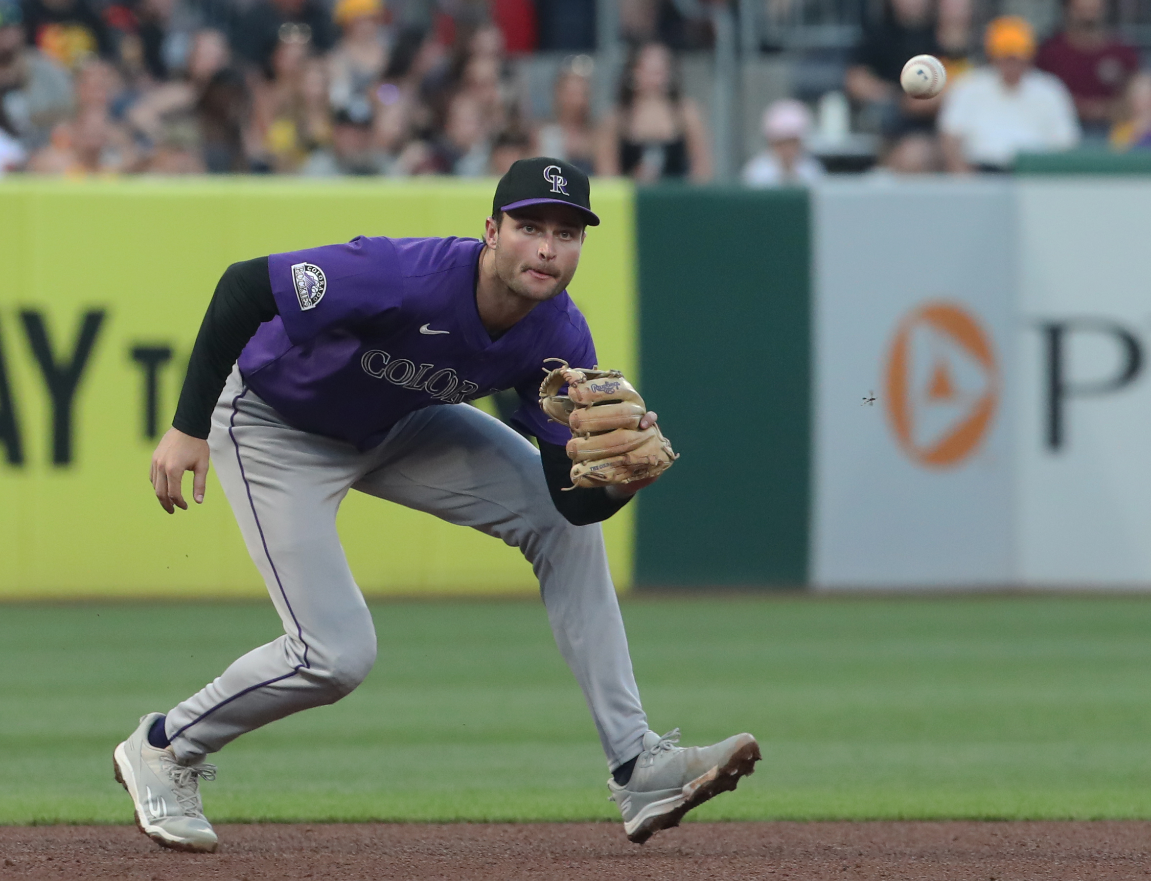 Aug 23, 2025; Pittsburgh, Pennsylvania, USA;  Colorado Rockies third baseman Kyle Karros (12) fields a ground ball for an out against Pittsburgh Pirates designated hitter Andrew McCutchen (not pictured) during the fourth inning at PNC Park. Mandatory Credit: Charles LeClaire-Imagn Images