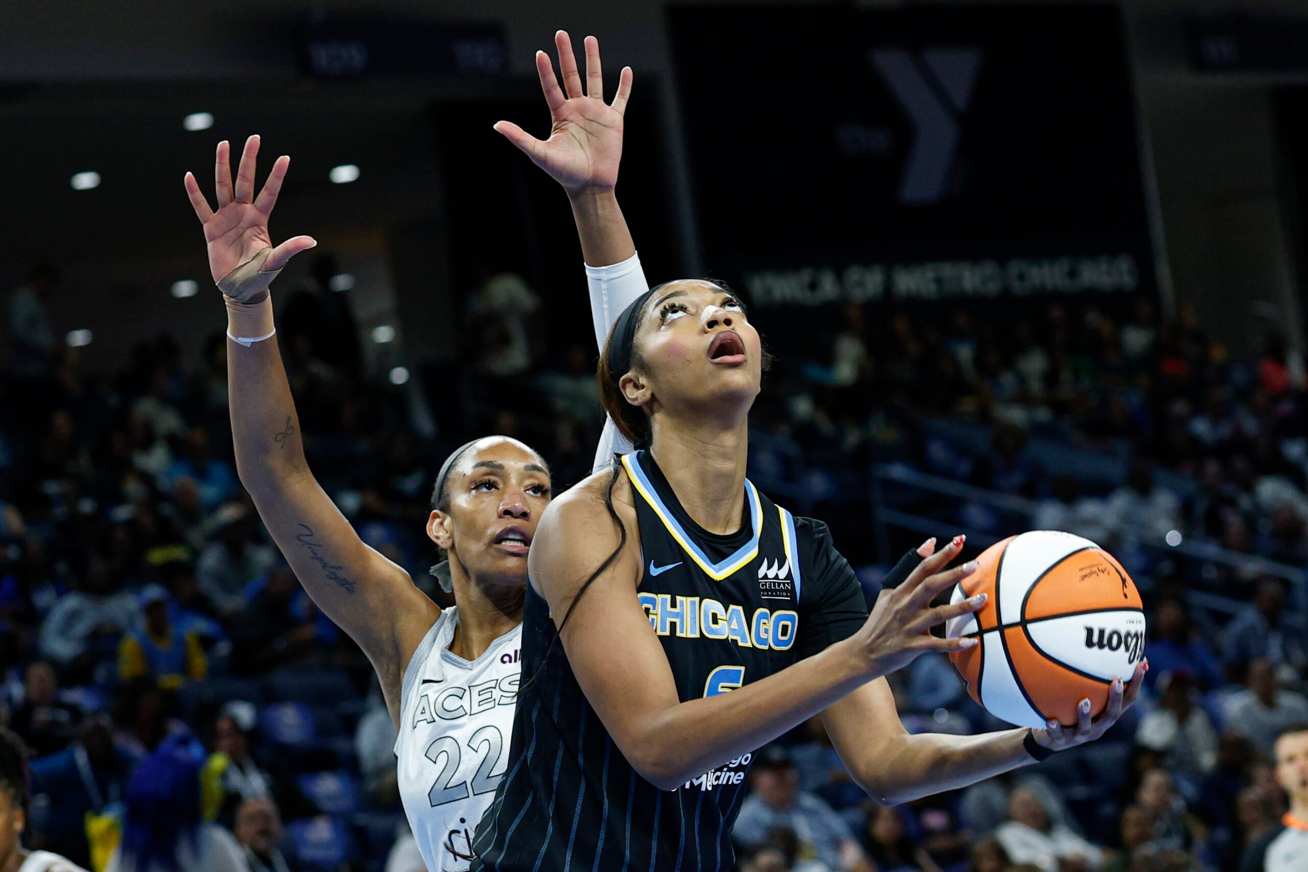 Aug 25, 2025; Chicago, Illinois, USA; Chicago Sky forward Angel Reese (5) drives to the basket against Las Vegas Aces center A'ja Wilson (22) during the first half at Wintrust Arena. Mandatory Credit: Kamil Krzaczynski-Imagn Images