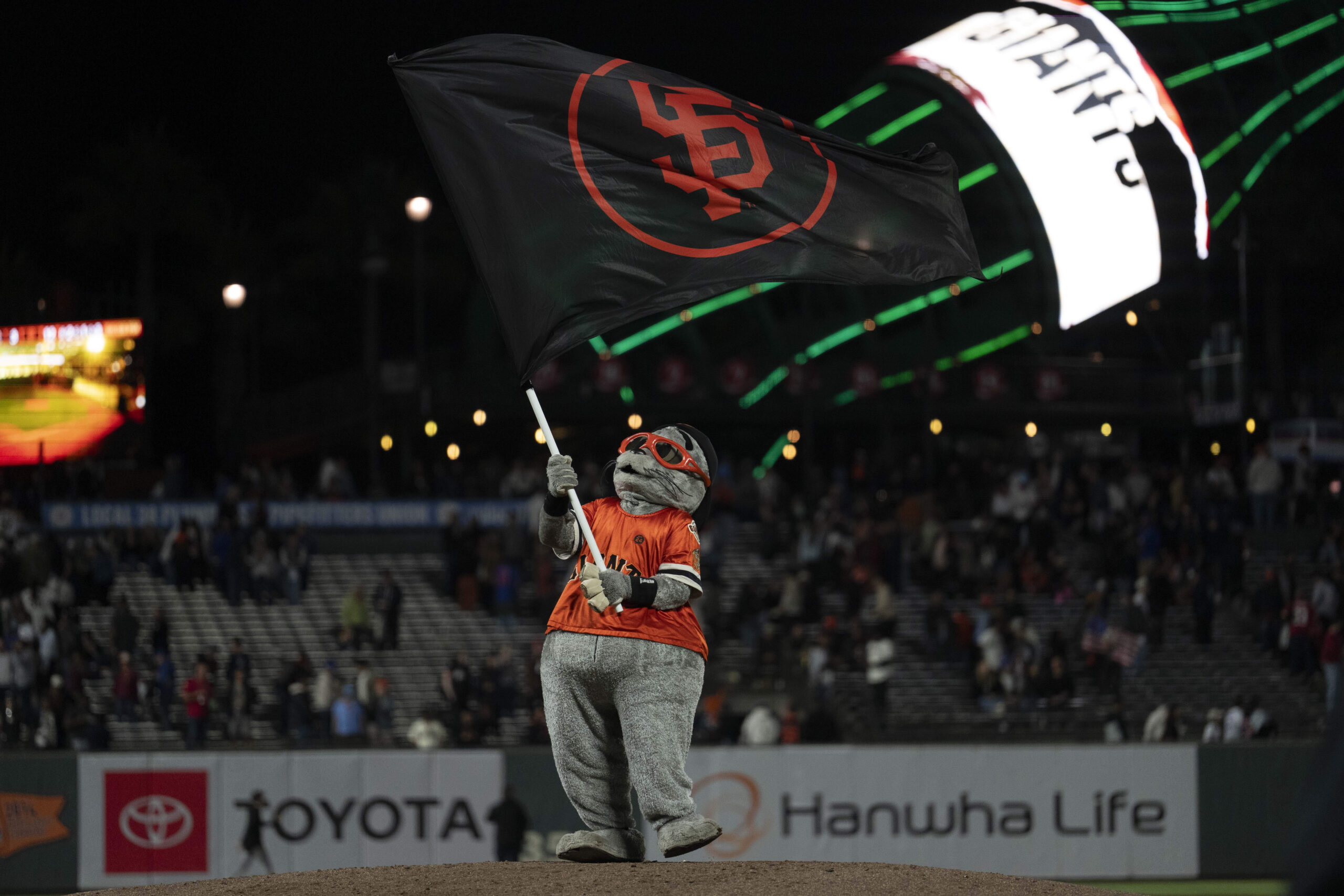Aug 27, 2025; San Francisco, California, USA; San Francisco Giants mascot Lou Seal celebrates after defeating the Chicago Cubs at Oracle Park. Mandatory Credit: Stan Szeto-Imagn Images