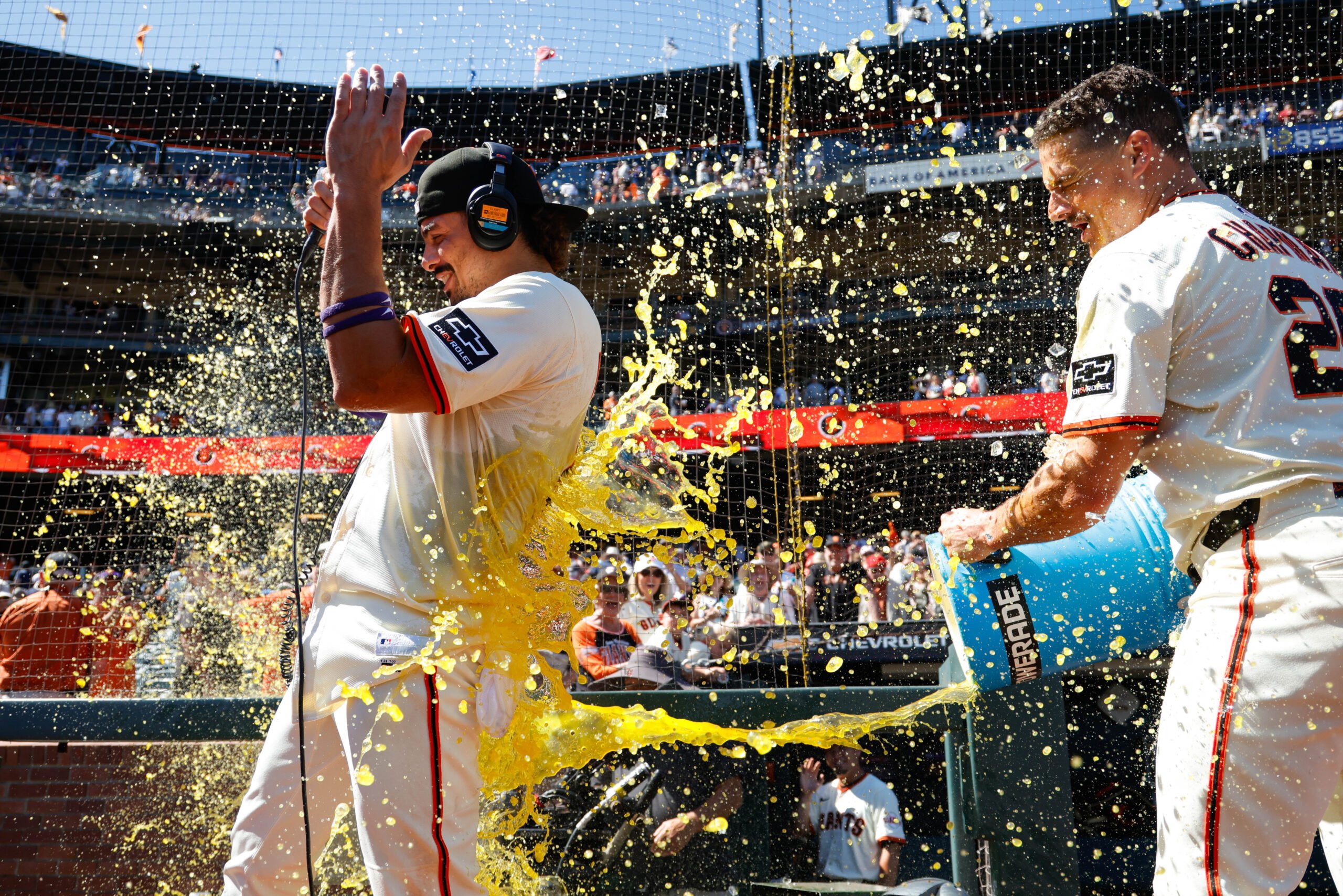 Aug 28, 2025; San Francisco, California, USA; San Francisco Giants shortstop Willy Adames (2) gets a gatorade splash by third baseman Matt Chapman (26) after the game against the Chicago Cubs at Oracle Park. Mandatory Credit: Sergio Estrada-Imagn Images