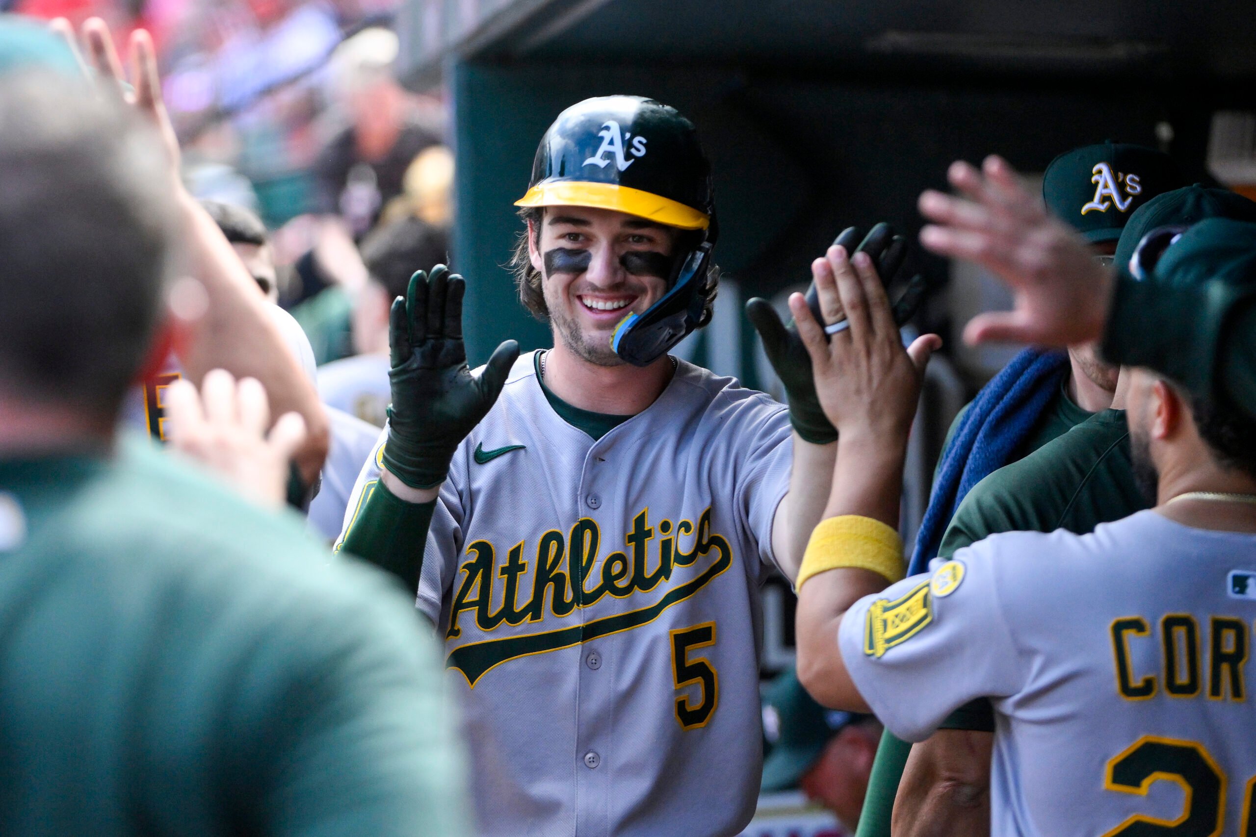 Sep 1, 2025; St. Louis, Missouri, USA;  Athletics shortstop Jacob Wilson (5) is congratulated by teammates after scoring against the St. Louis Cardinals during the seventh inning at Busch Stadium. Mandatory Credit: Jeff Curry-Imagn Images