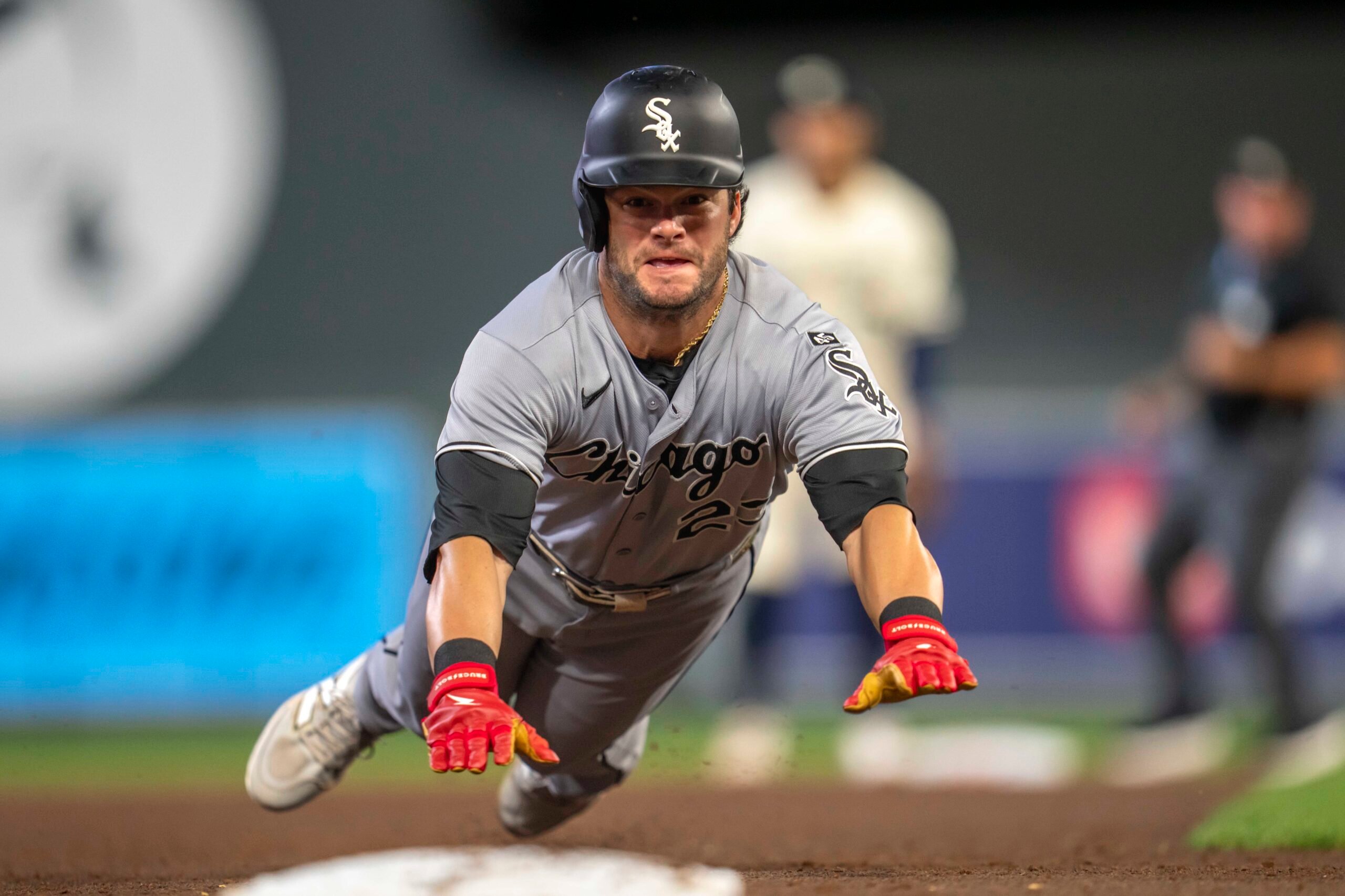 Sep 2, 2025; Minneapolis, Minnesota, USA; Chicago White Sox left fielder Andrew Benintendi (23) slides into third base safely after a fly ball against the Minnesota Twins in the sixth inning at Target Field. Mandatory Credit: Jesse Johnson-Imagn Images
