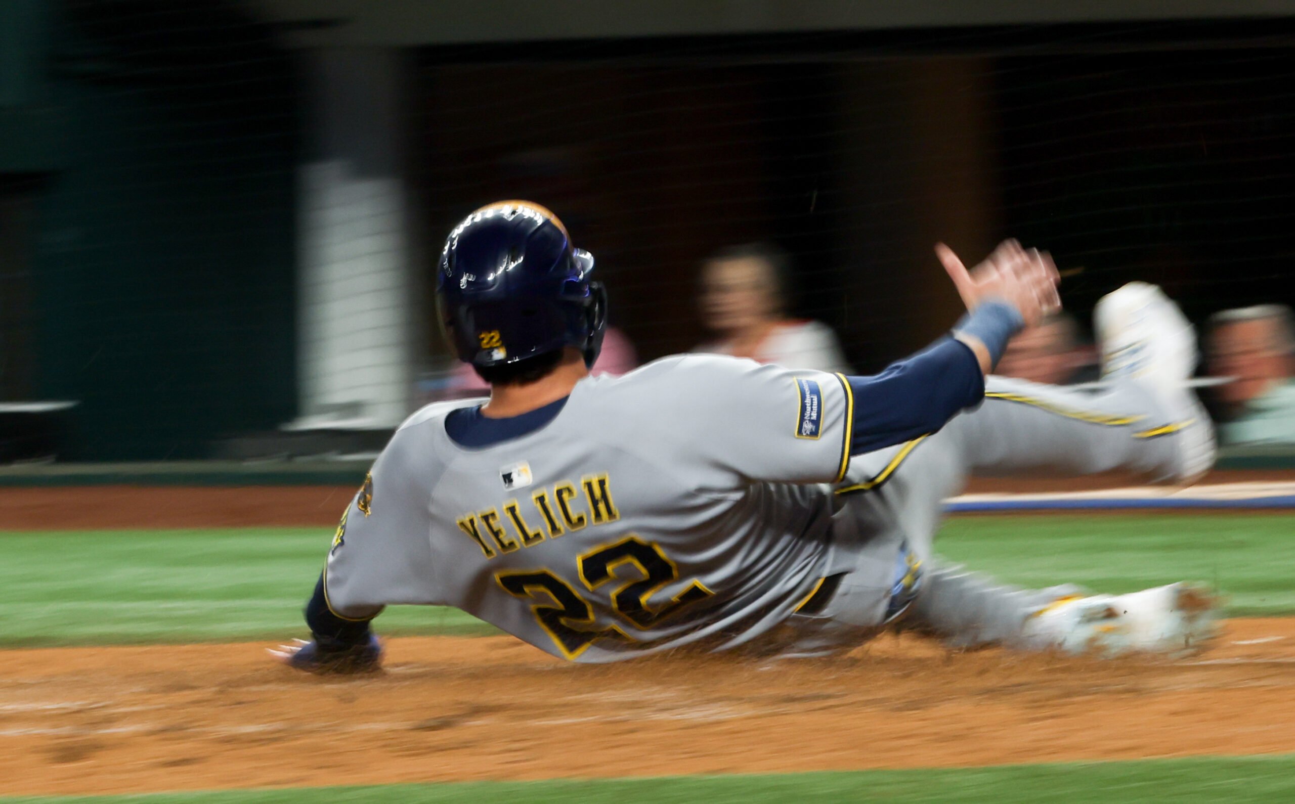 Sep 9, 2025; Arlington, Texas, USA; (Editor's note: Slow shutter image.) Milwaukee Brewers designated hitter Christian Yelich (22) scores during the fifth inning against the Texas Rangers at Globe Life Field. Mandatory Credit: Kevin Jairaj-Imagn Images