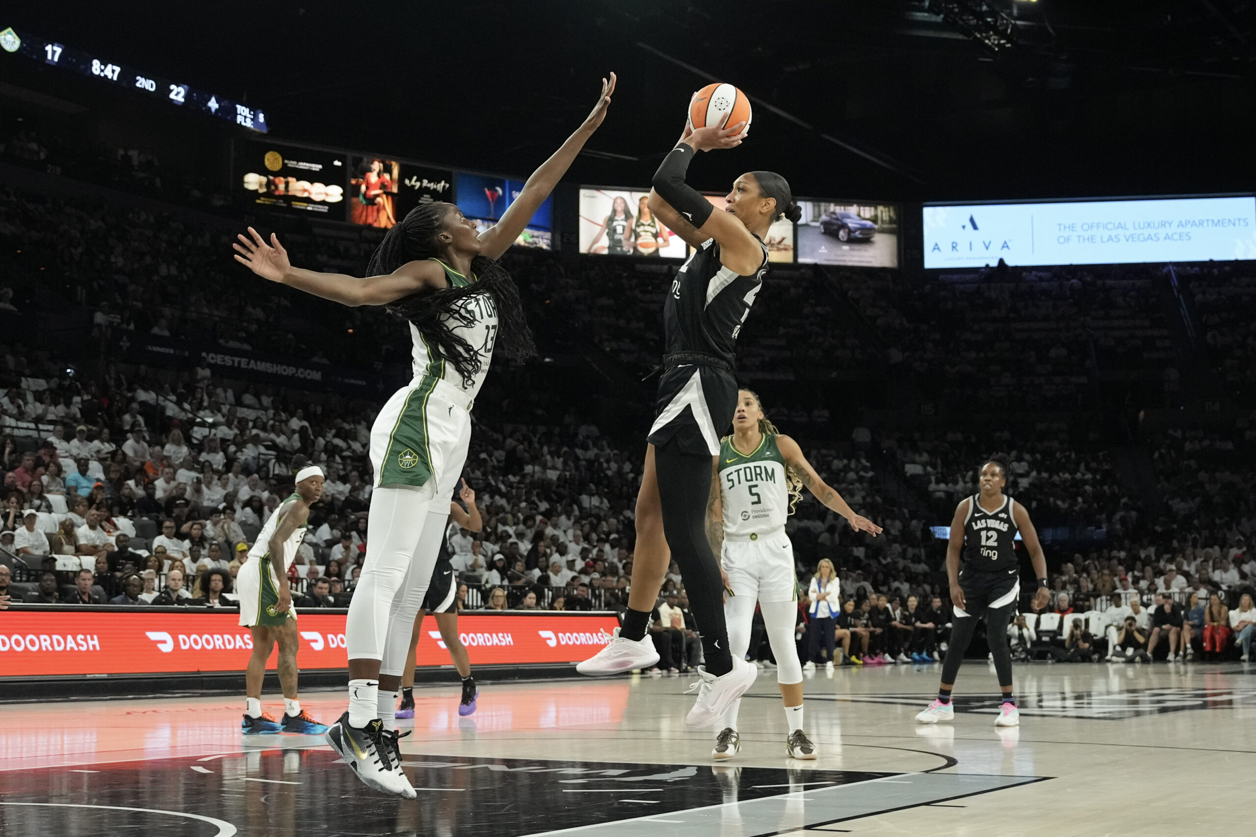 Sep 14, 2025; Las Vegas, Nevada, USA; Las Vegas Aces center A'ja Wilson (22) shoots against Seattle Storm forward Ezi Magbegor (13) in the second quarter during game one of round one for the 2025 WNBA Playoffs at Michelob Ultra Arena. Mandatory Credit: Candice Ward-Imagn Images
