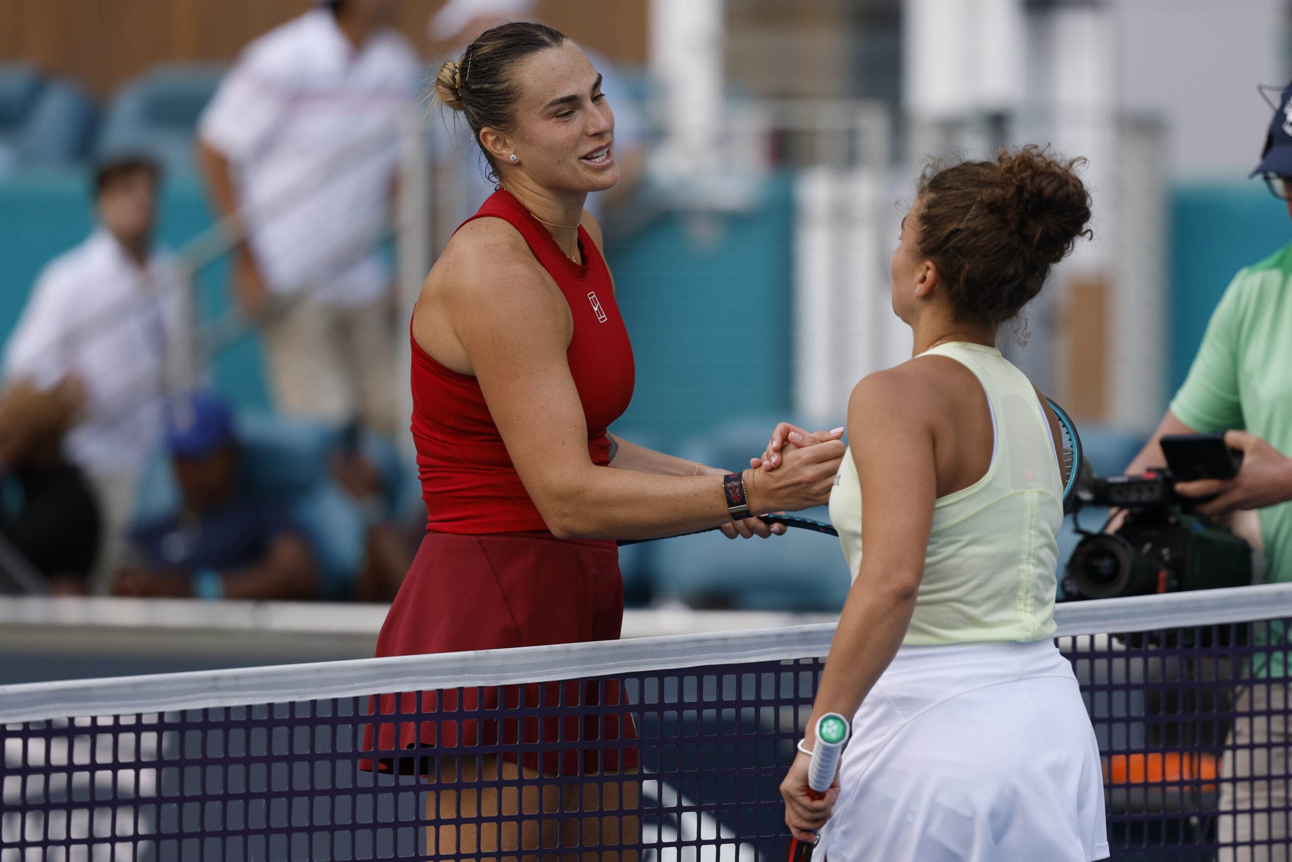 Mar 27, 2025; Miami, FL, USA; Aryna Sabalenka (L) shakes hands with Jasmine Paolini (ITA)(R) at the net after their women's singles semifinal on day ten of the Miami Open at Hard Rock Stadium. Mandatory Credit: Geoff Burke-Imagn Images