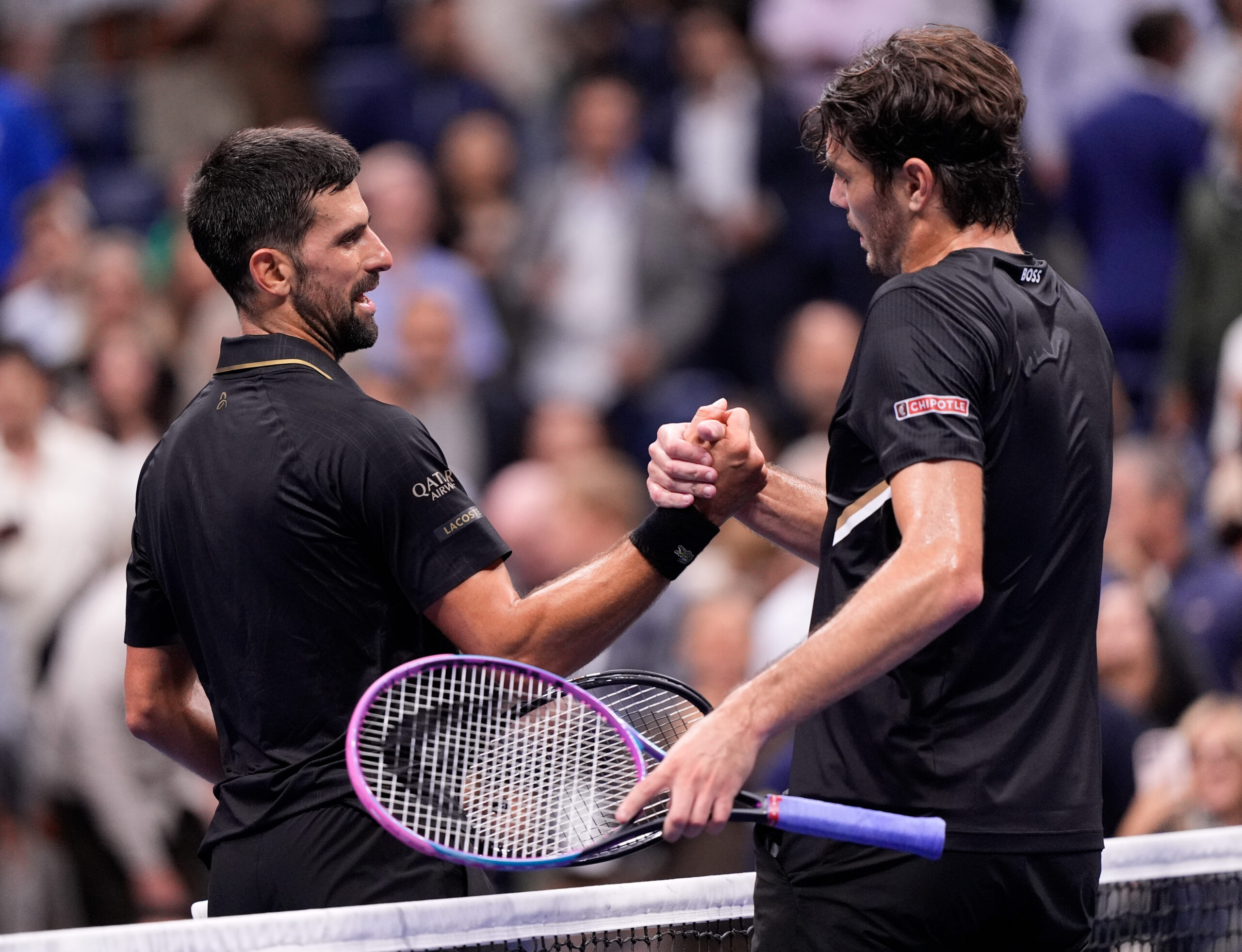 Sep 2, 2025; Flushing, NY, USA;
Novak Djokovic (SRB) (left) after defeating Taylor Fritz (USA) (right) on day ten of the 2025 U.S. Open tennis tournament at the USTA Billie Jean King National Tennis Center. Mandatory Credit: Robert Deutsch-Imagn Images
