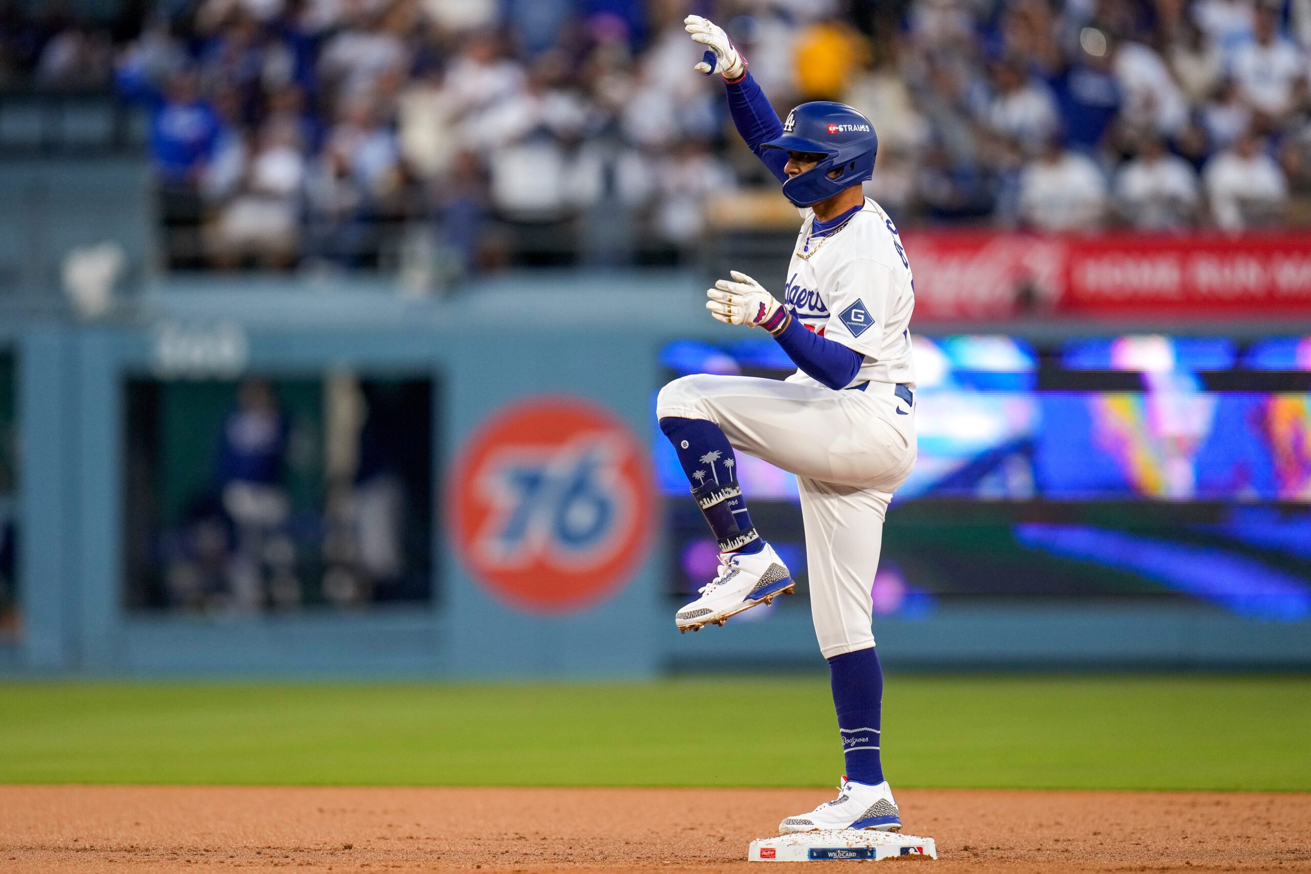 Los Angeles Dodgers shortstop Mookie Betts (50) celebrates a double in the first inning of the MLB National League Wild Card Game 2 between the Los Angeles Dodgers and the Cincinnati Reds at Dodger Stadium in Los Angeles on Wednesday, Oct. 1, 2025. The Reds were eliminated from the postseason with an 8-4 loss to the reining World Series Champions La Dodgers.