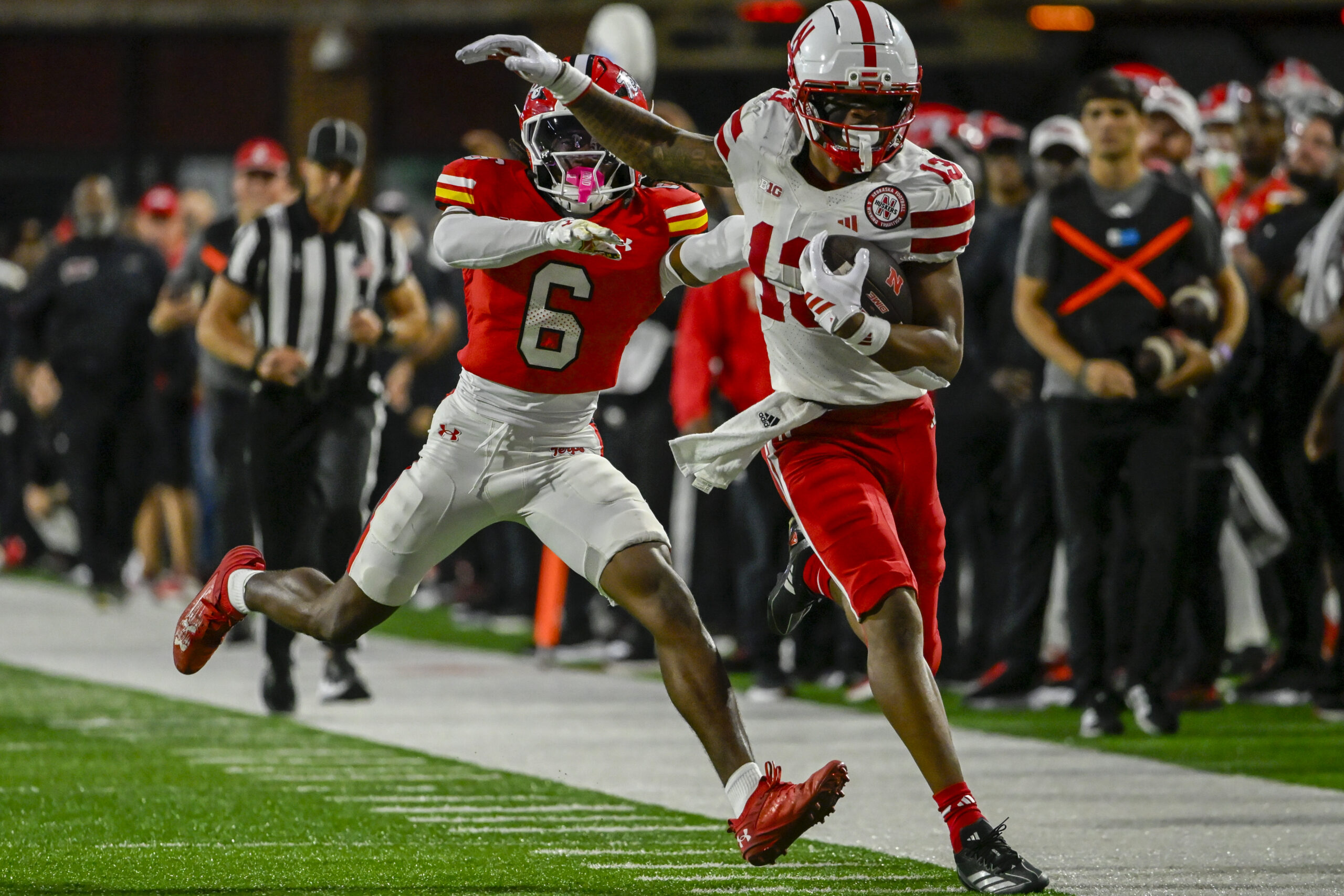 Oct 11, 2025; College Park, Maryland, USA; Nebraska Cornhuskers wide receiver Nyziah Hunter (13) runs for a first down as Maryland Terrapins defensive back Dontay Joyner (6) defends during the second half at SECU Stadium. Mandatory Credit: Tommy Gilligan-Imagn Images