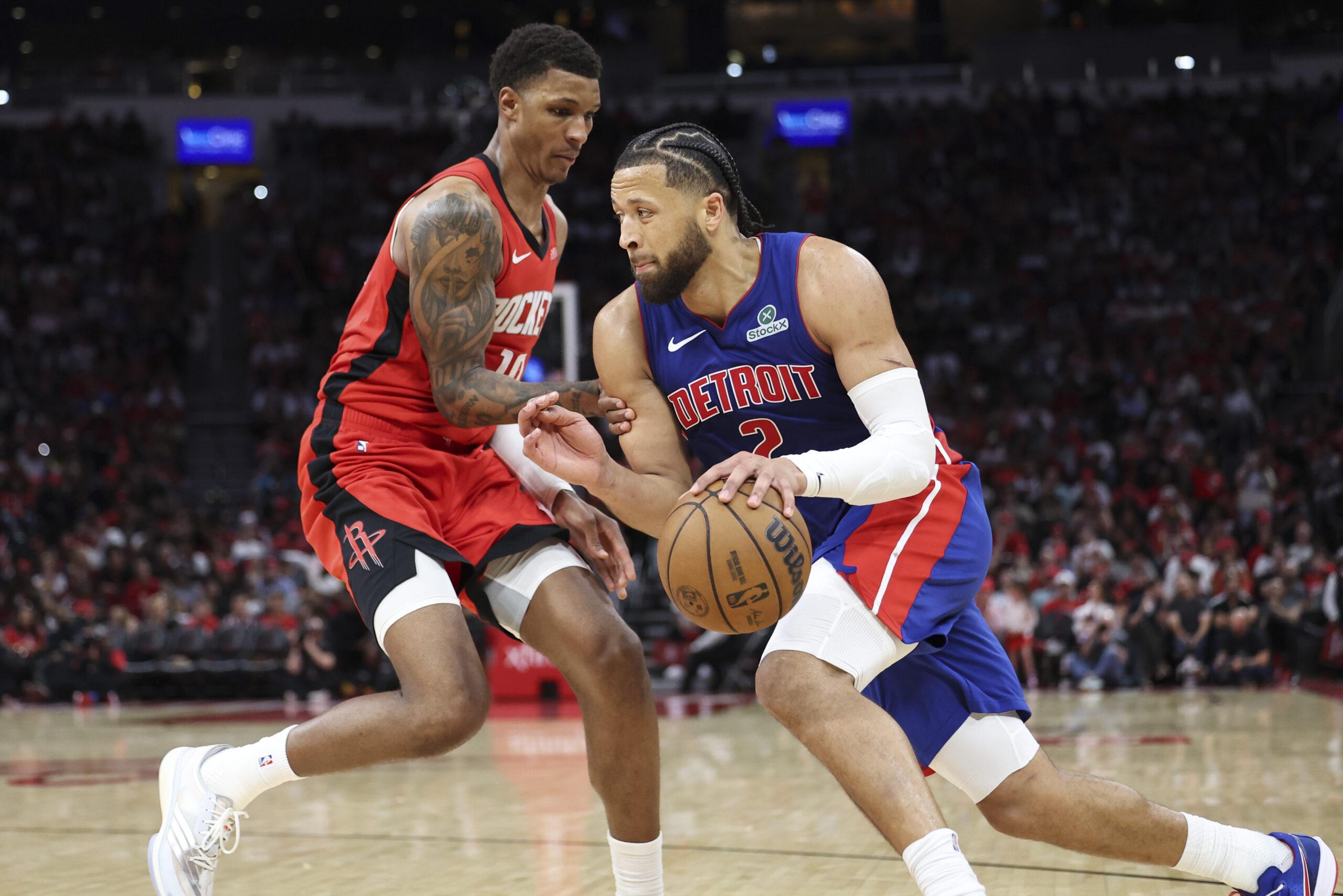 Oct 24, 2025; Houston, Texas, USA; Detroit Pistons guard Cade Cunningham (2) drives with the ball as Houston Rockets forward Jabari Smith Jr. (10) defends during the fourth quarter at Toyota Center. Mandatory Credit: Troy Taormina-Imagn Images