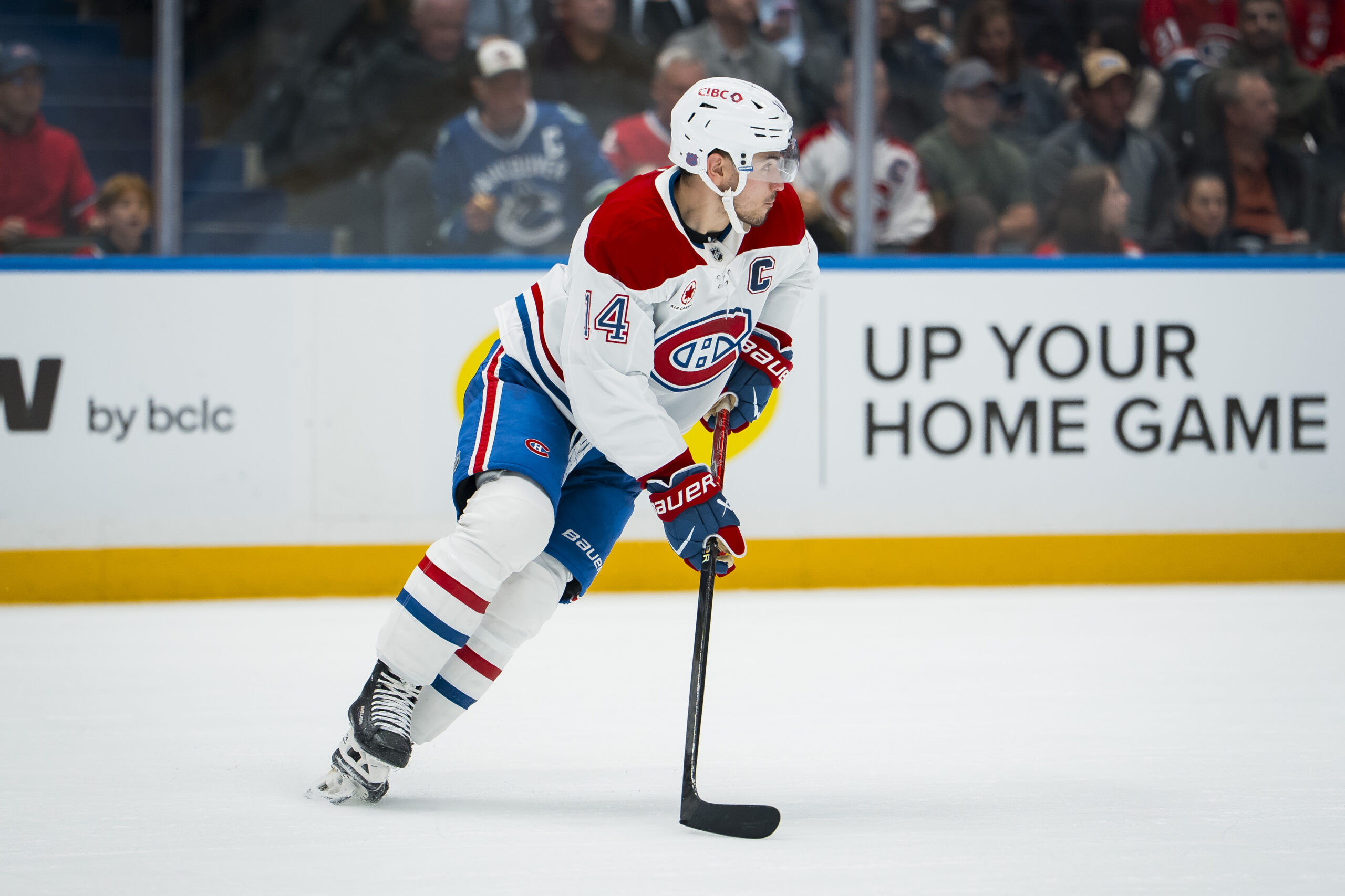 Oct 25, 2025; Vancouver, British Columbia, CAN; Montreal Canadiens forward Nick Suzuki (14) handles the puck against the Vancouver Canucks in the second period at Rogers Arena. Mandatory Credit: Bob Frid-Imagn Images