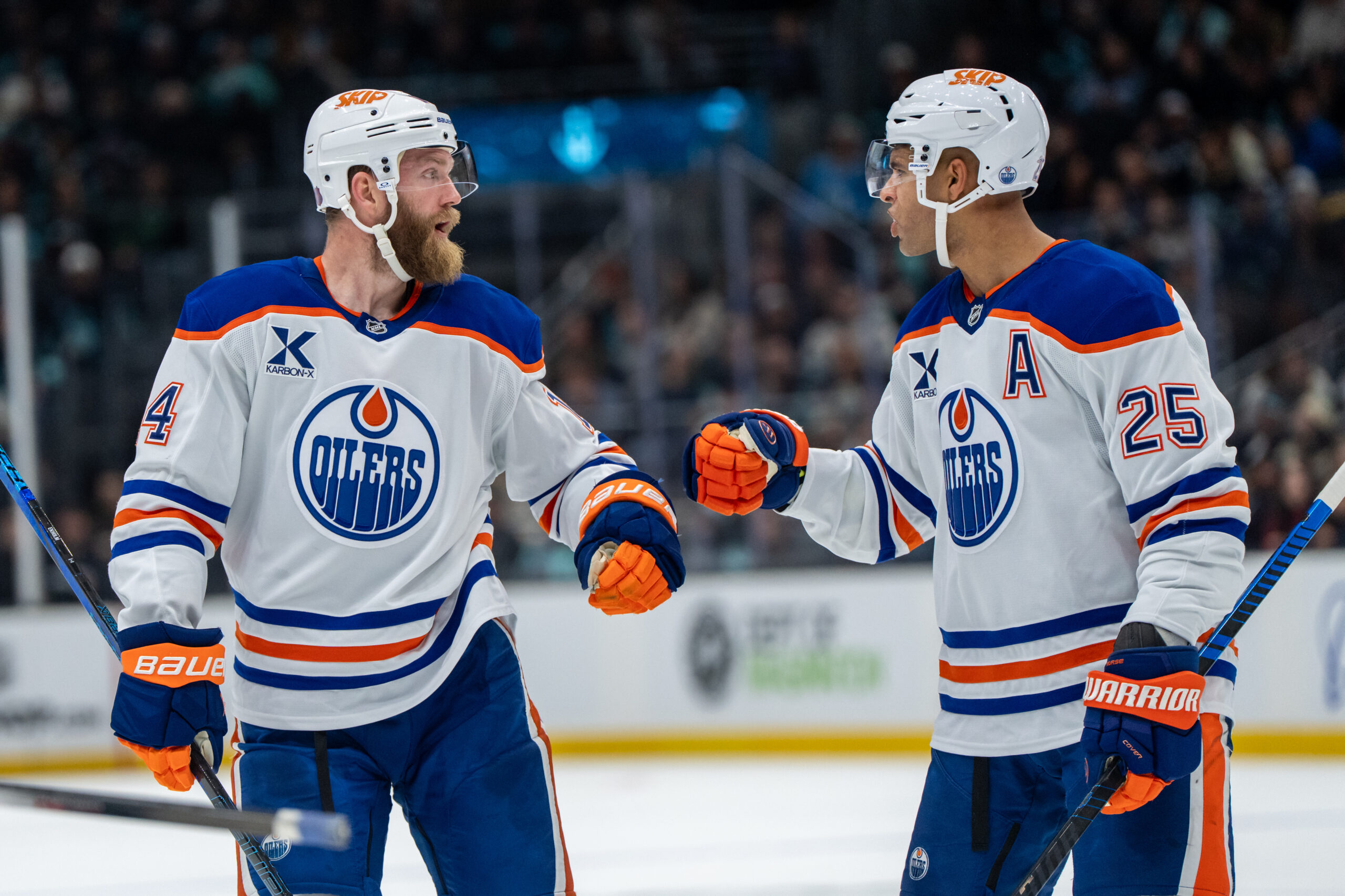 Oct 25, 2025; Seattle, Washington, USA; Edmonton Oilers defenseman Mattias Ekholm (14) and defenseman Darnell Nurse (25) celebrate after a goal during the third period against the Seattle Kraken at Climate Pledge Arena. Mandatory Credit: Stephen Brashear-Imagn Images