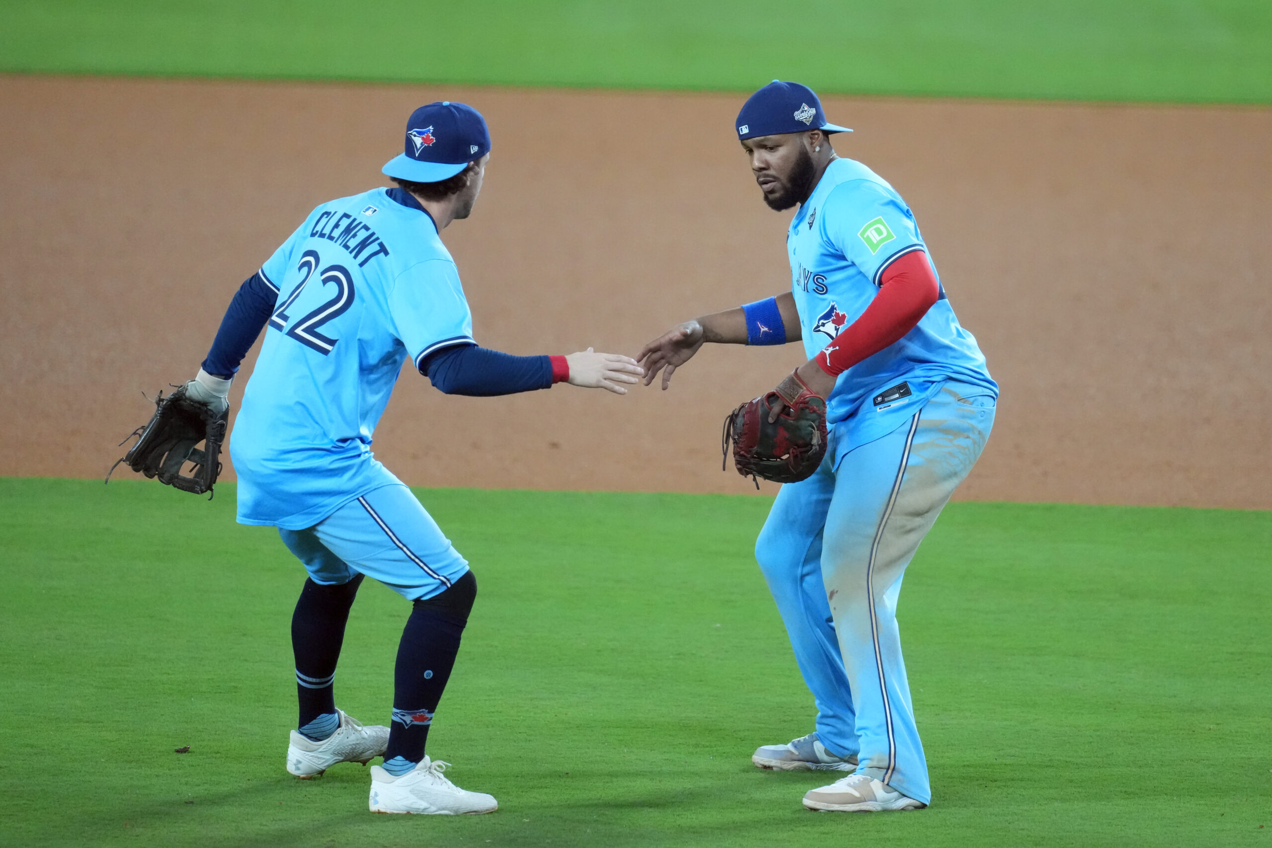 Oct 29, 2025; Los Angeles, California, USA; Toronto Blue Jays first baseman Vladimir Guerrero Jr. (27) celebrates with third baseman Ernie Clement (22) after defeating the Los Angeles Dodgers in game five of the 2025 MLB World Series at Dodger Stadium. Mandatory Credit: Kirby Lee-Imagn Images