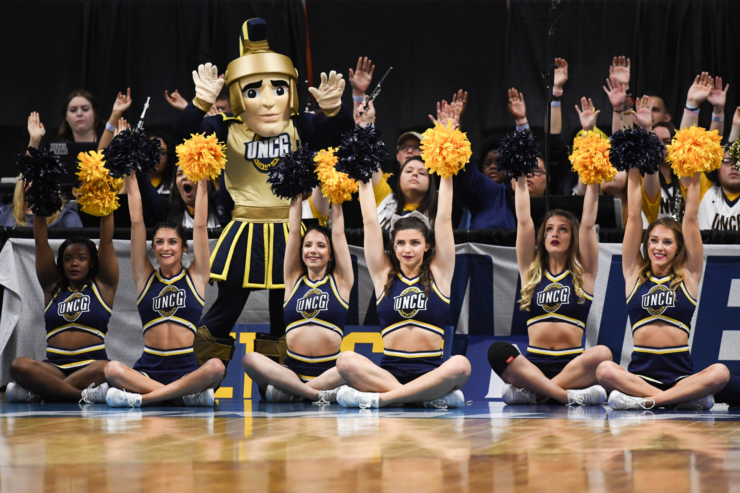 Mar 15, 2018; Boise, ID, USA; UNC-Greensboro Spartans cheerleaders and mascot cheer from courtside in the first half between the UNC-Greensboro Spartans and the Gonzaga Bulldogs during the first round of the 2018 NCAA Tournament at Taco Bell Arena. Mandatory Credit: Kyle Terada-Imagn Images