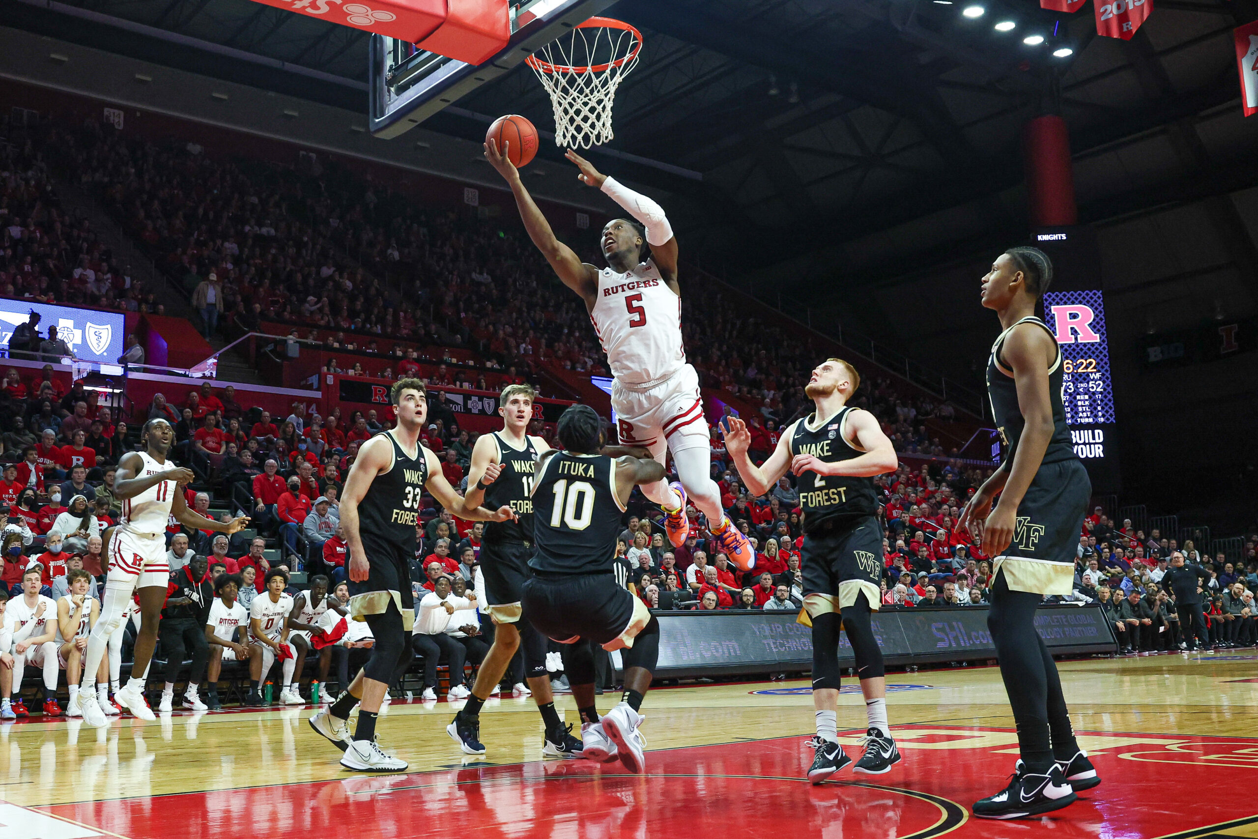 Dec 17, 2022; Piscataway, New Jersey, USA; Rutgers Scarlet Knights forward Aundre Hyatt (5) drives to the basket as Wake Forest Demon Deacons guard Jao Ituka (10) defends during the second half at Jersey Mike's Arena. Mandatory Credit: Vincent Carchietta-Imagn Images