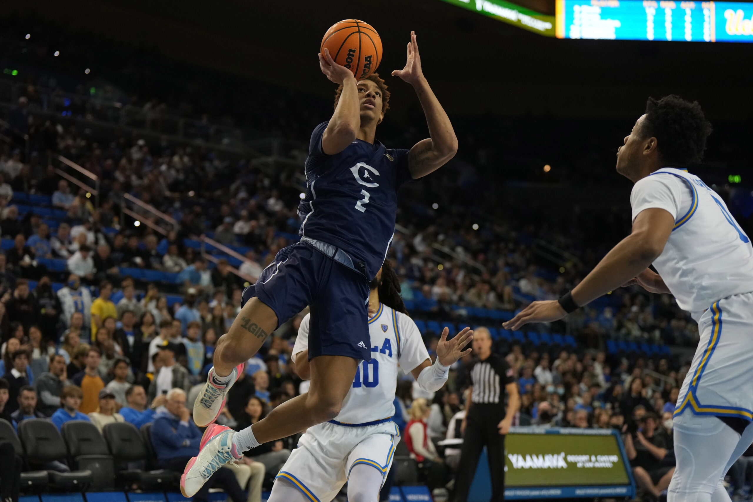 Dec 21, 2022; Los Angeles, California, USA; UC Davis Aggies guard Ty Johnson (2) shoots the ball against UCLA Bruins in the first half at Pauley Pavilion presented by Wescom. Mandatory Credit: Kirby Lee-Imagn Images