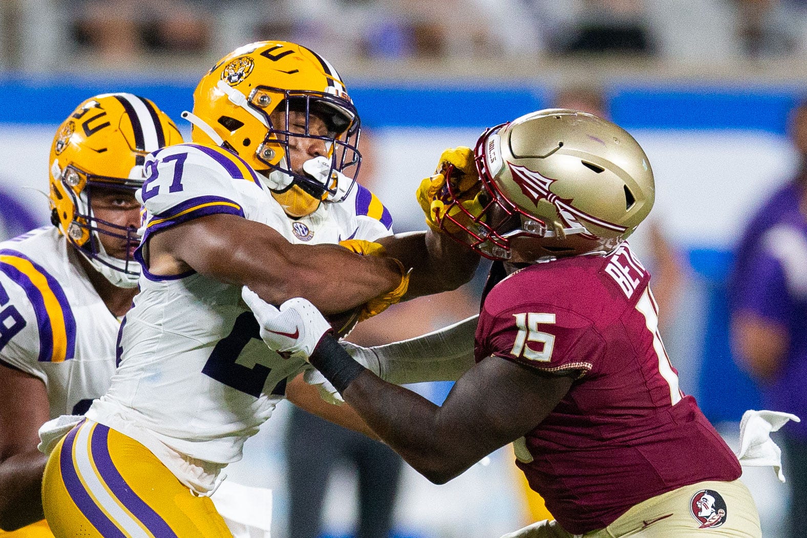 Florida State Seminoles linebacker Tatum Bethune (15) fights off LSU Tigers running back Josh Williams (27) during a game at Camping World Stadium on Sunday, Sept. 3, 2023.