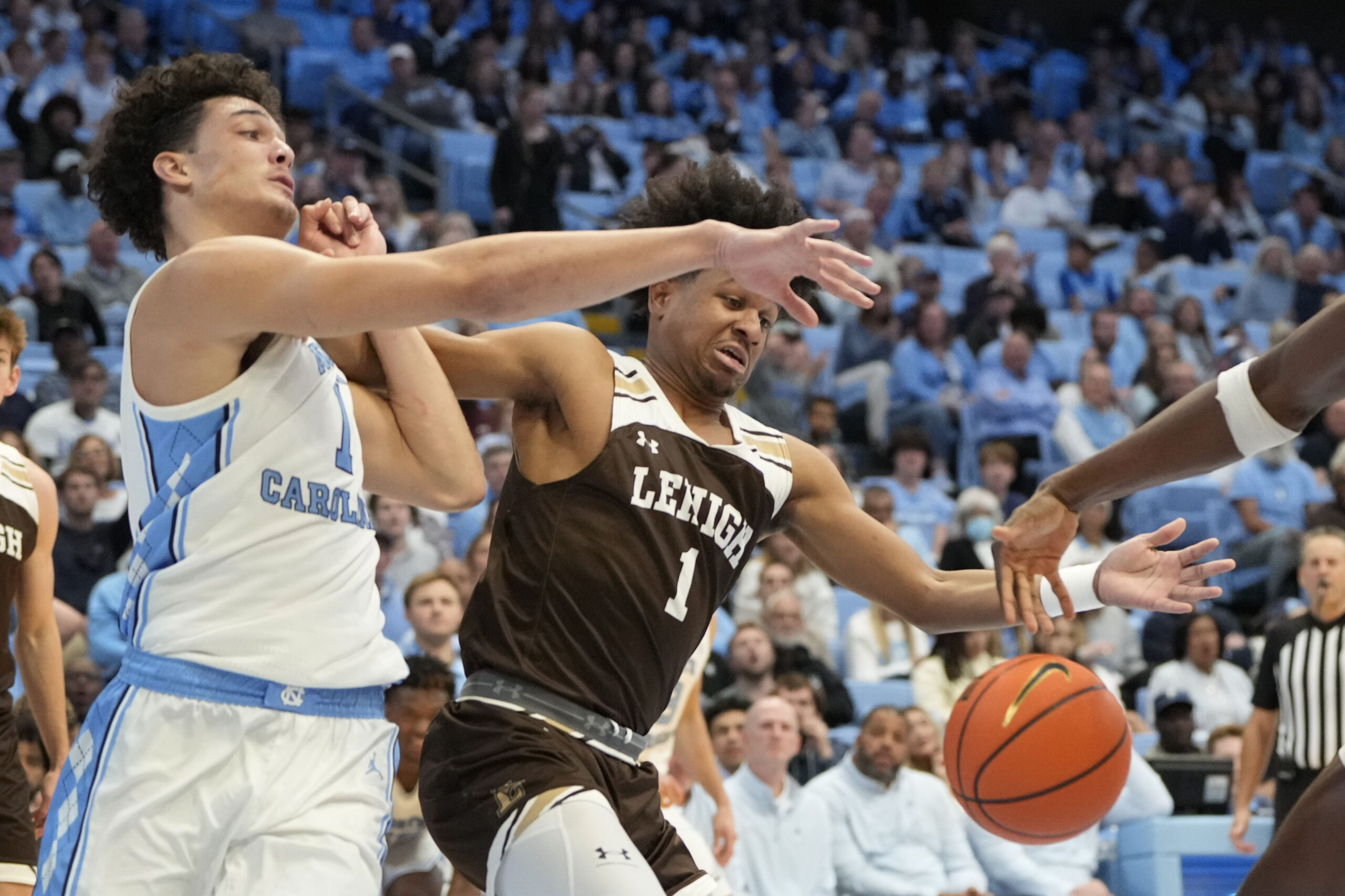 Nov 12, 2023; Chapel Hill, North Carolina, USA; North Carolina Tar Heels forward Zayden High (1) and Lehigh Mountain Hawks guard Nasir Whitlock (1) fight for the ball in the second half at Dean E. Smith Center. Mandatory Credit: Bob Donnan-Imagn Images