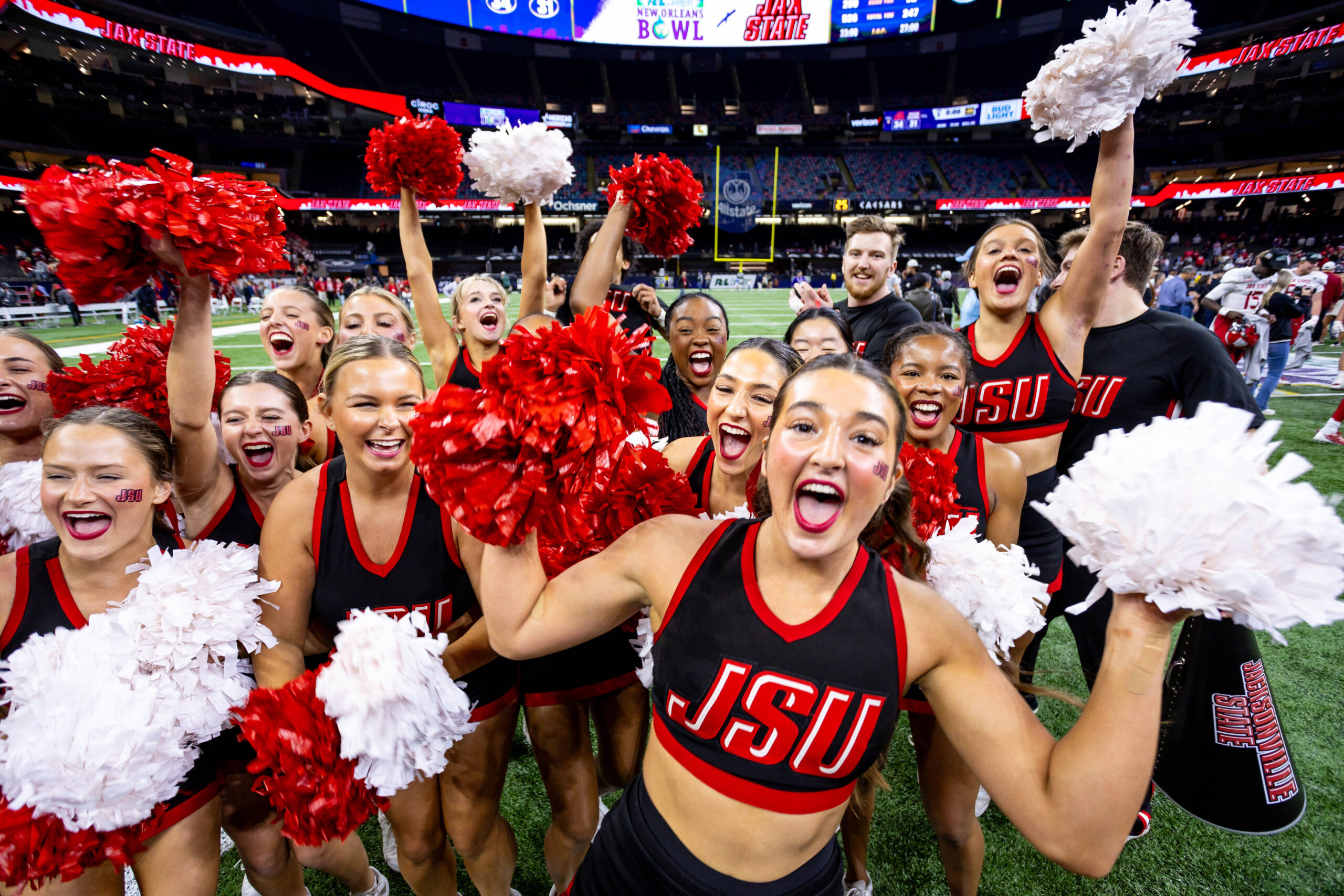 Dec 16, 2023; New Orleans, LA, USA; Jacksonville State Gamecocks cheerleaders celebrate a field goal to defeat the Louisiana-Lafayette Ragin Cajuns in overtime at the Caesars Superdome. Mandatory Credit: Stephen Lew-Imagn Images