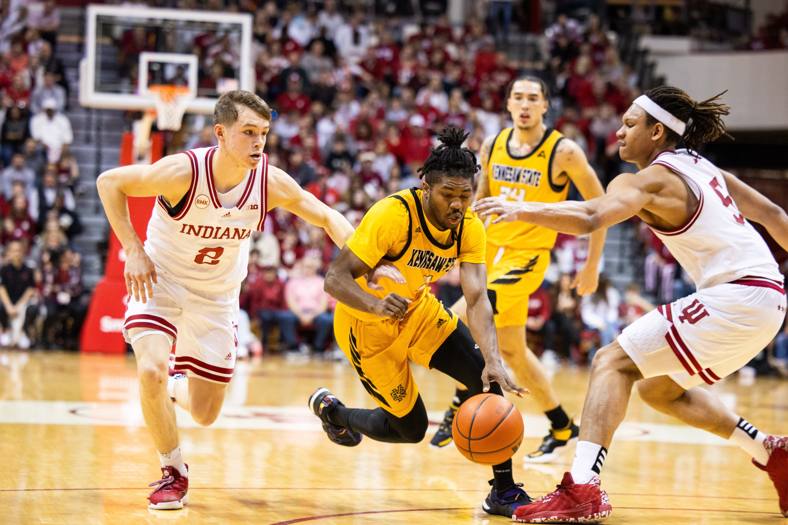 Dec 29, 2023; Bloomington, Indiana, USA; Kennesaw State Owls guard Terrell Burden (1) dribbles the ball while Indiana Hoosiers guard Gabe Cupps (2) and forward Malik Reneau (5) defend in the second half at Simon Skjodt Assembly Hall. Mandatory Credit: Trevor Ruszkowski-Imagn Images