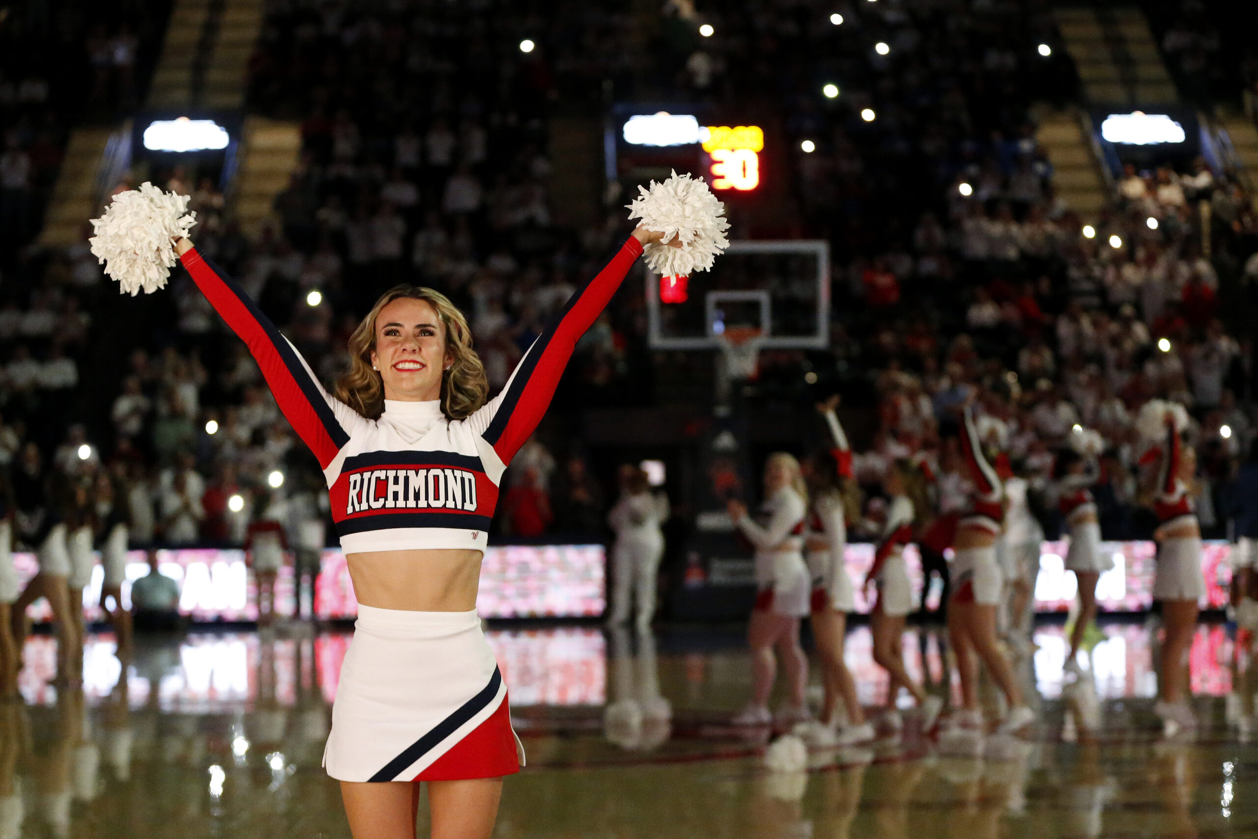 Jan 27, 2024; Richmond, Virginia, USA; A Richmond Spiders cheerleader looks on from the court prior to the Spiders' game against the Dayton Flyers during the first half at the Robins Center. Mandatory Credit: Amber Searls-Imagn Images