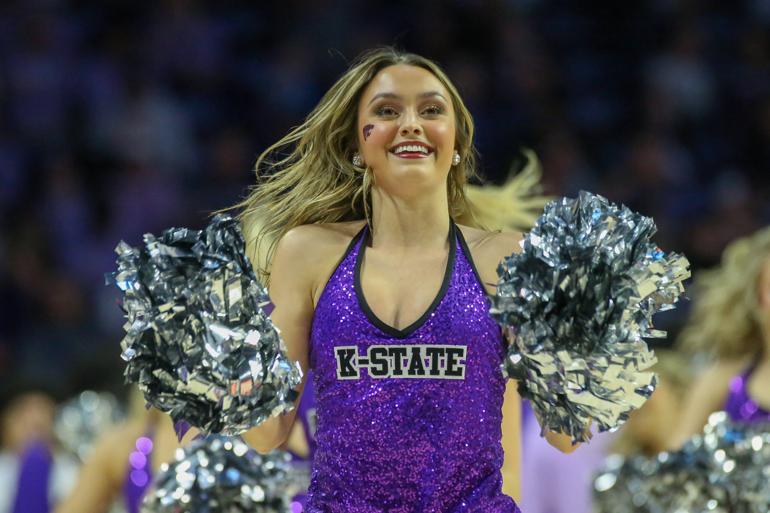 Mar 9, 2024; Manhattan, Kansas, USA; A Kansas State Wildcats cheerleader performs during a timeout of a game against the Iowa State Cyclones at Bramlage Coliseum. Mandatory Credit: Scott Sewell-Imagn Images