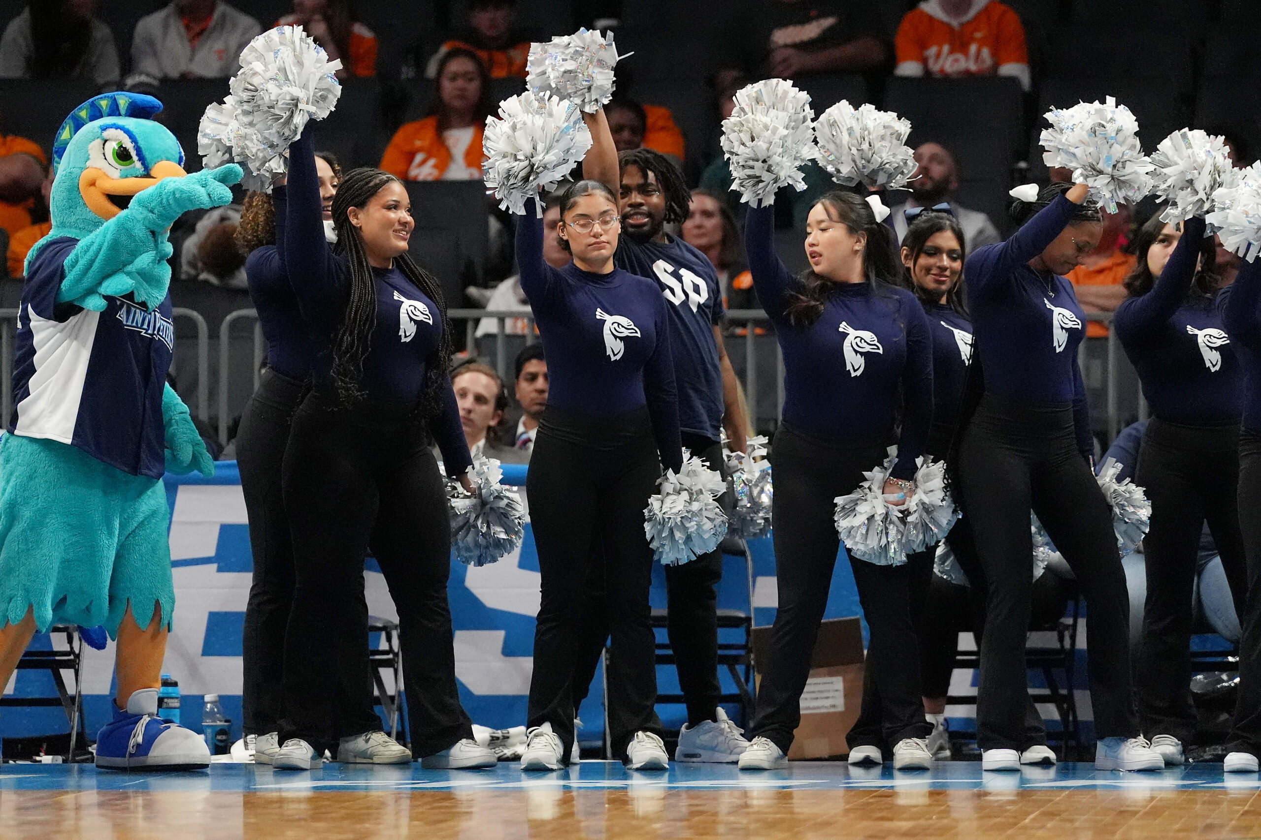 Mar 21, 2024; Charlotte, NC, USA; Saint Peter's Peacocks cheerleaders perform in the first round of the 2024 NCAA Tournament at Spectrum Center. Mandatory Credit: Jim Dedmon-Imagn Images