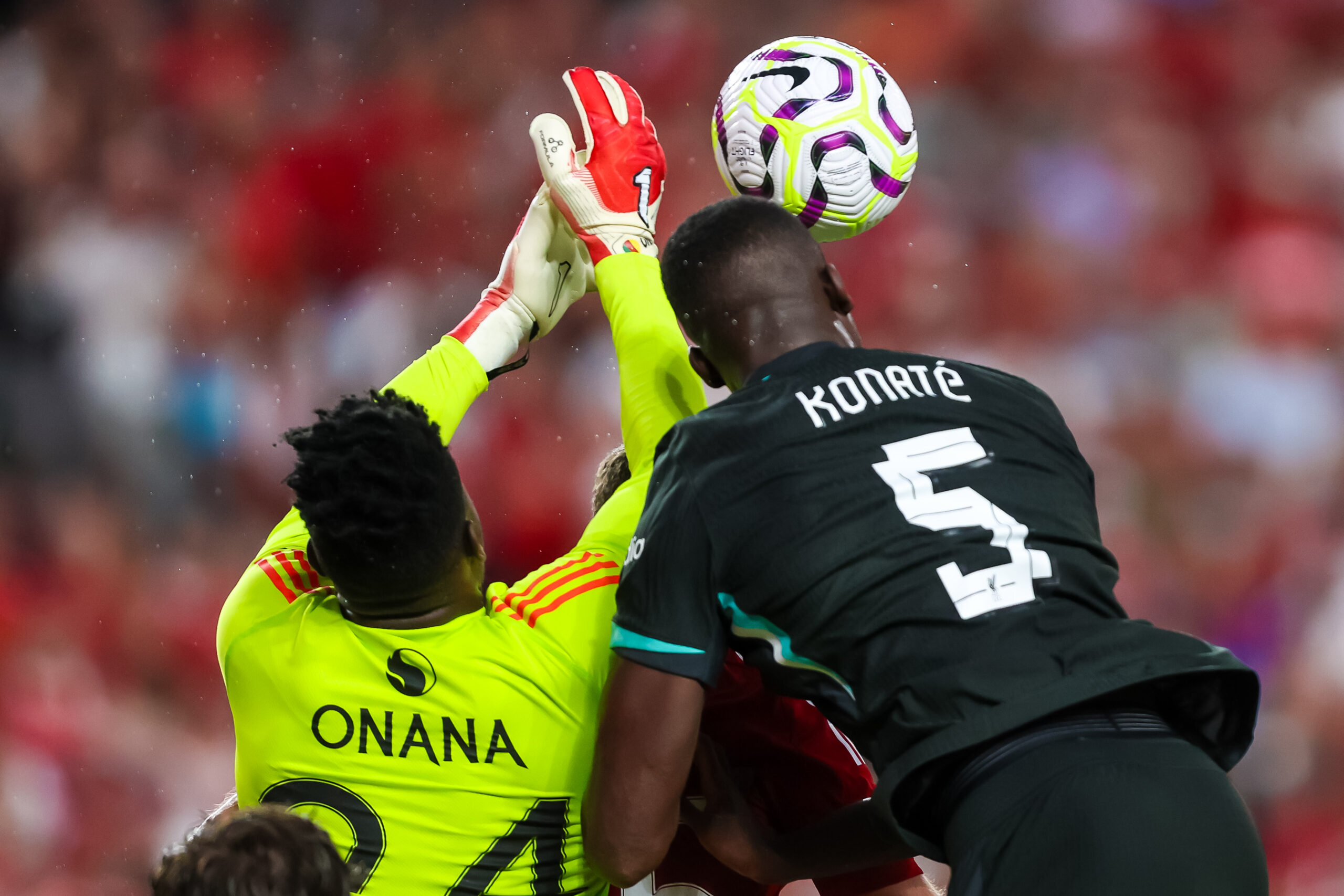 Aug 3, 2024; Columbia, South Carolina, USA; Manchester United goalkeeper André Onana (24) and Liverpool defender Ibrahima Konaté (5) battle for the ball at Williams-Brice Stadium. Mandatory Credit: Jeff Blake-Imagn Images