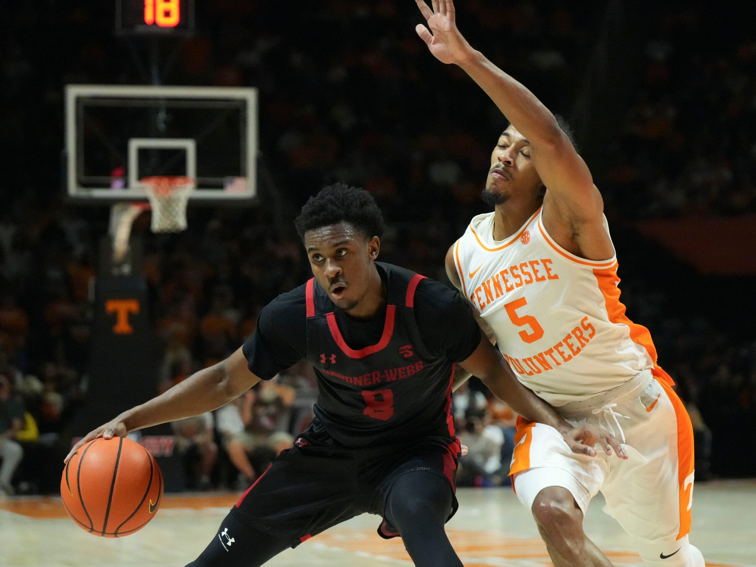 Gardner-Webb guard Darryl Simmons II (8) tries to get to the basket while defended by Tennessee guard Zakai Zeigler (5) during an NCAA college basketball game on Monday, Nov. 4, 2024, in Knoxville, Tenn.