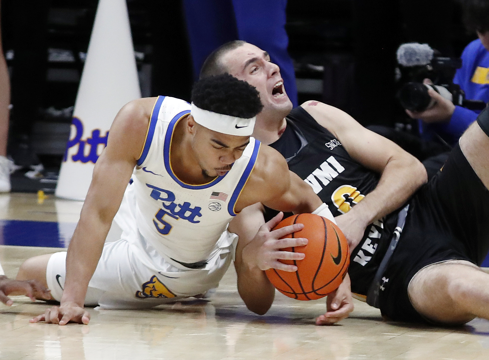 Nov 18, 2024; Pittsburgh, Pennsylvania, USA;  Pittsburgh Panthers guard Ishmael Leggett (5) and Virginia Military Keydets forward Cal Liston (0) fight for the ball during the second half at the Petersen Events Center. Mandatory Credit: Charles LeClaire-Imagn Images