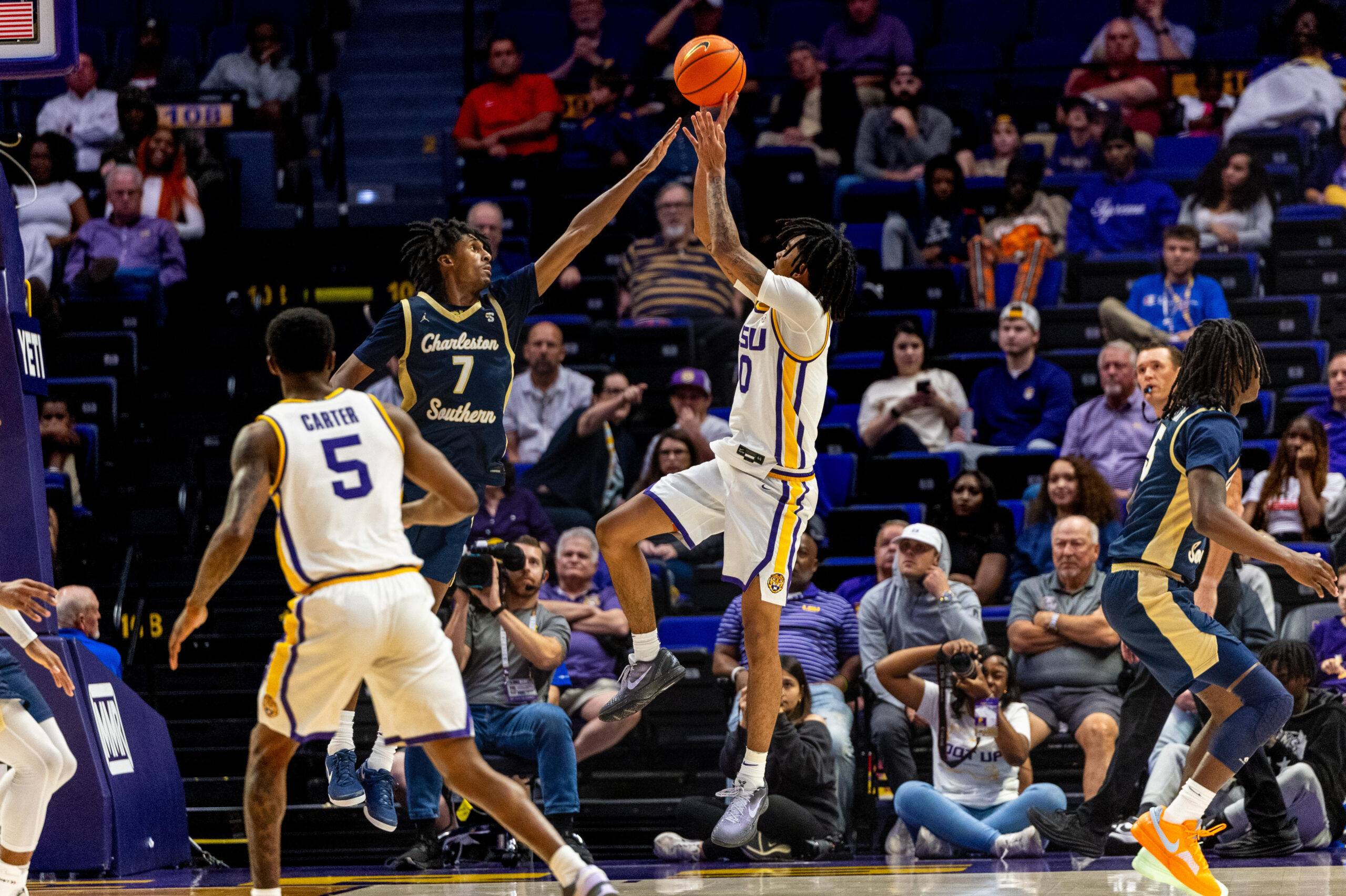 Nov 19, 2024; Baton Rouge, Louisiana, USA; LSU Tigers forward Daimion Collins (10) shoots a jump shot against Charleston Southern Buccaneers guard Daylen Berry (7) during the second half at Pete Maravich Assembly Center. Mandatory Credit: Stephen Lew-Imagn Images