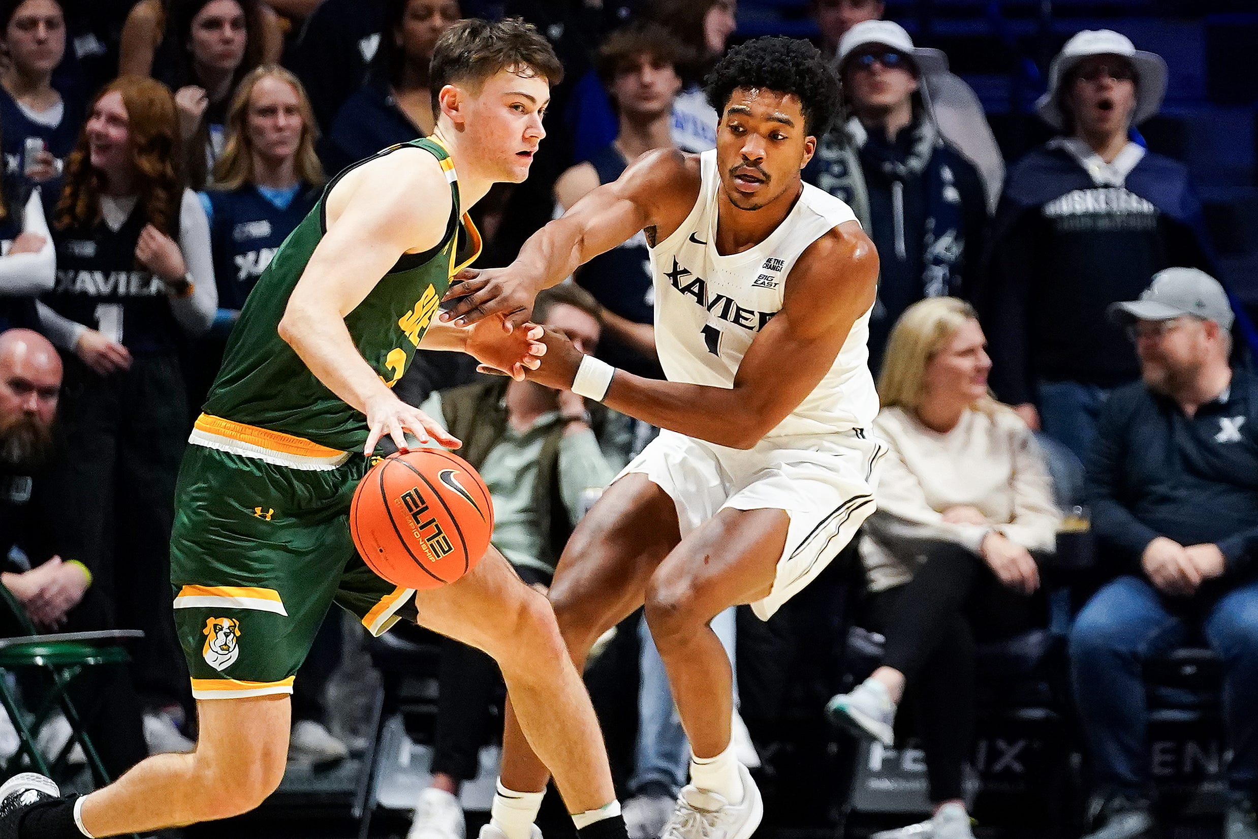 Xavier Musketeers guard Marcus Foster (1) defends against Siena Saints forward Brendan Coyle (21) in the second half of a college basketball game between the Xavier Musketeers and Siena Saints, Wednesday, Nov. 20, 2024, at Cintas Center in Cincinnati. Musketeers won 80-55.