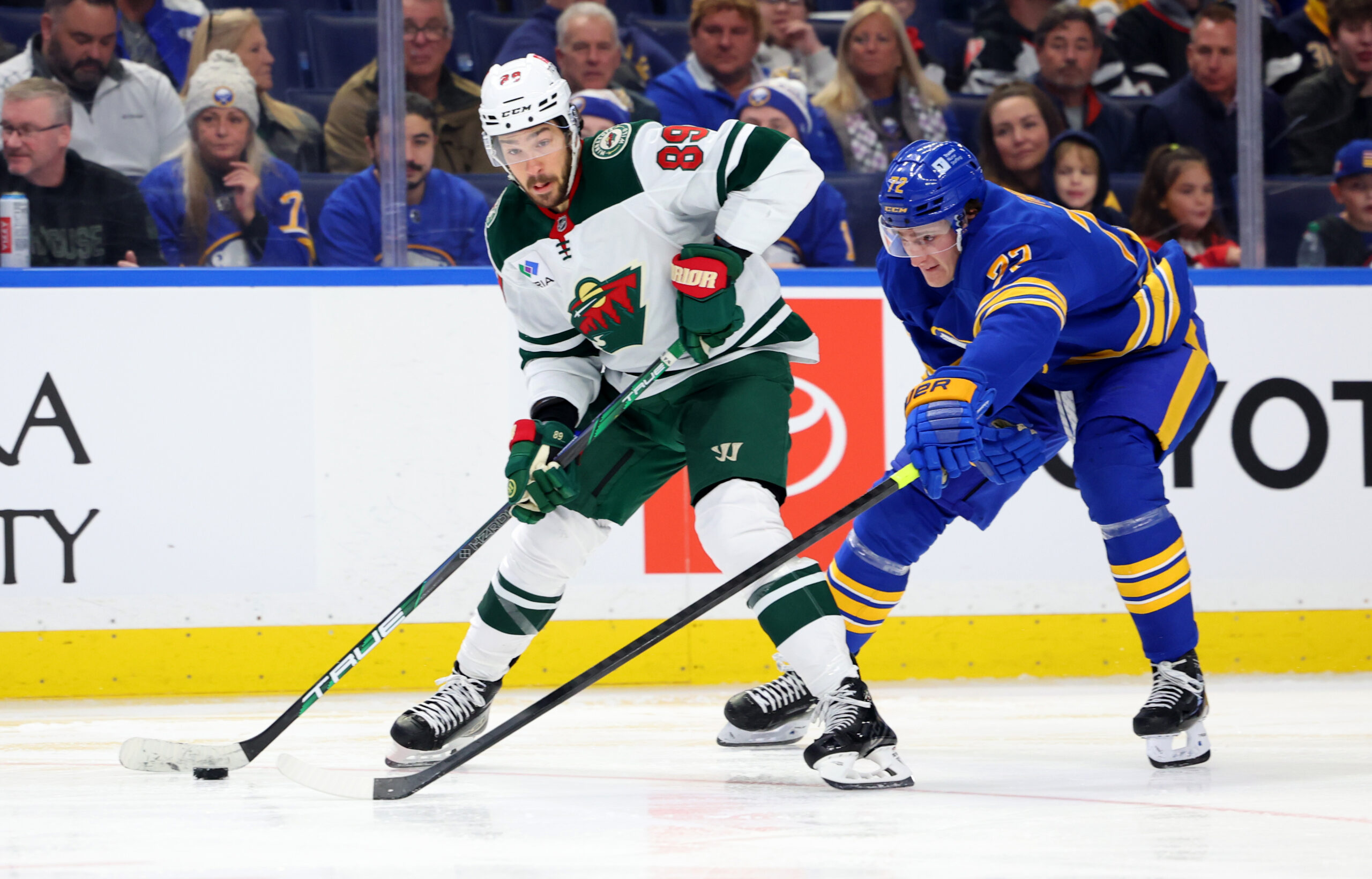 Nov 27, 2024; Buffalo, New York, USA;  Buffalo Sabres center Tage Thompson (72) tries to block a pass by Minnesota Wild center Frederick Gaudreau (89) during the third period at KeyBank Center. Mandatory Credit: Timothy T. Ludwig-Imagn Images