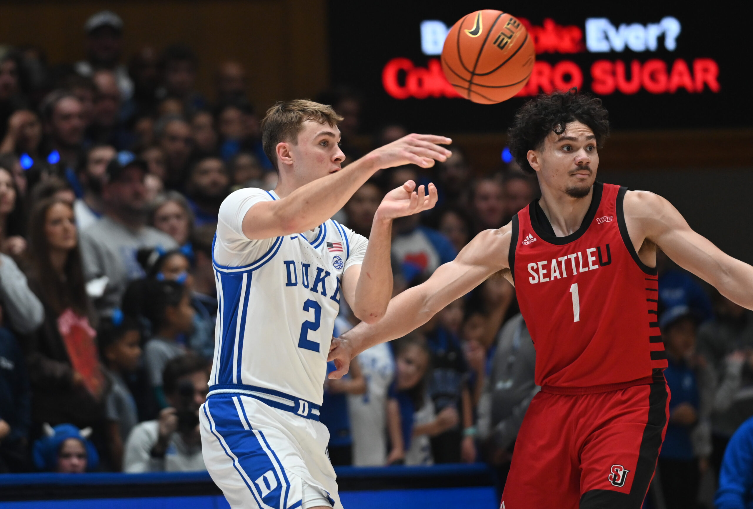 Nov 29, 2024; Durham, North Carolina, USA; Duke Blue Devils forward Cooper Flagg (2) throws a pass in front of Seattle Redhawks guard Maleek Arington (1) during the first half at Cameron Indoor Stadium. Mandatory Credit: Rob Kinnan-Imagn Images