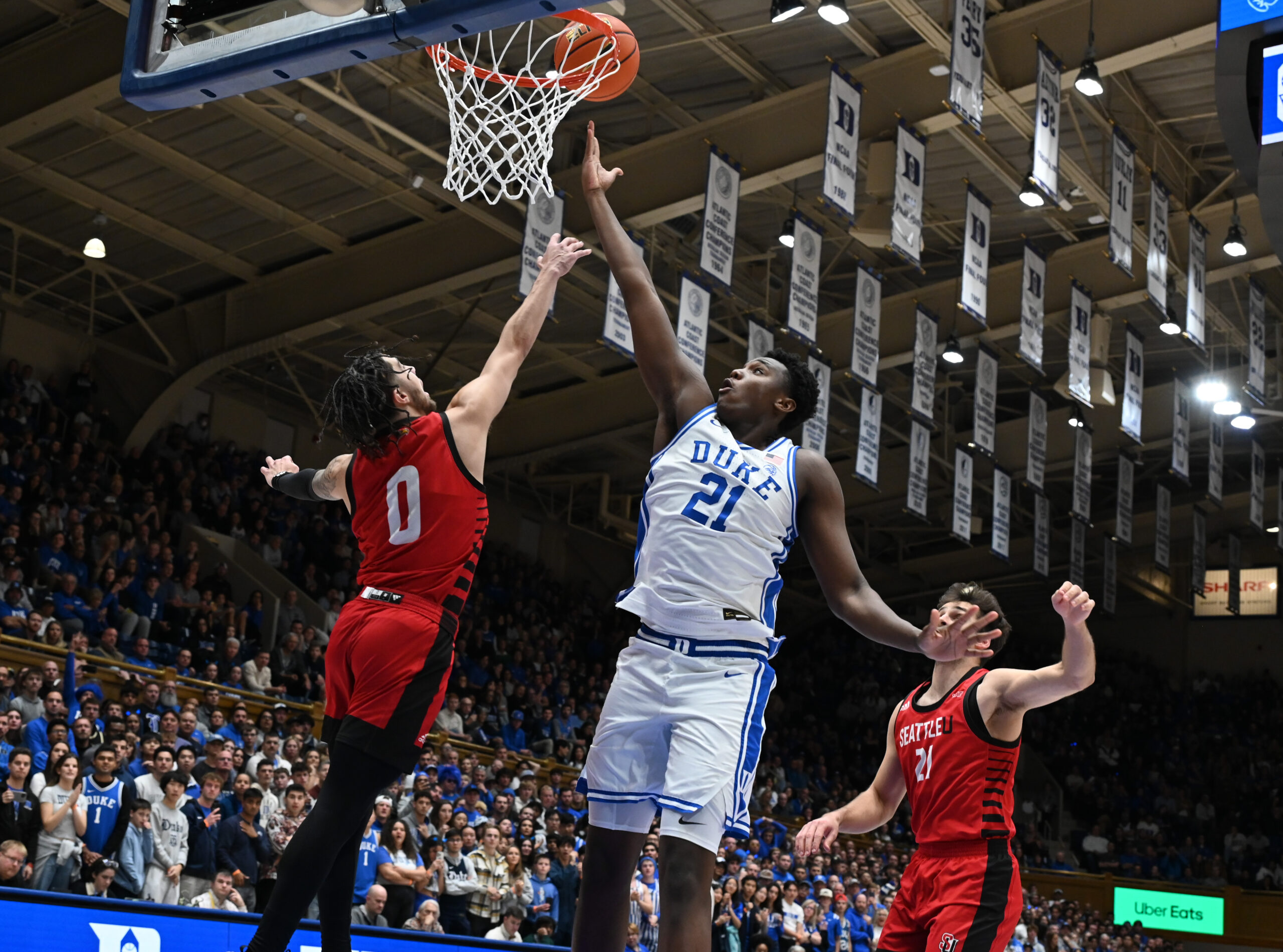 Nov 29, 2024; Durham, North Carolina, USA; Duke Blue Devils center Patrick Ngongba II (21) lays the ball up over Seattle Redhawks guard Brayden Maldonado (0) during the second half at Cameron Indoor Stadium. Mandatory Credit: Rob Kinnan-Imagn Images