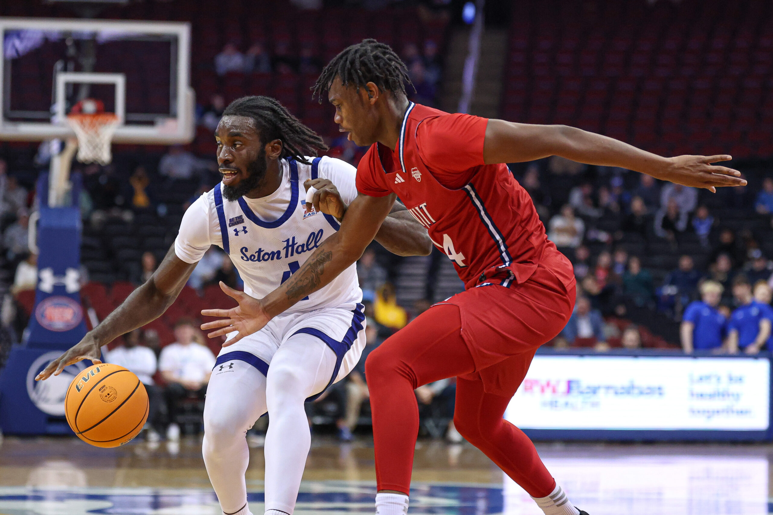 Dec 4, 2024; Newark, New Jersey, USA; Seton Hall Pirates forward Prince Aligbe (4) is guarded by NJIT Highlanders guard Ari Fulton (24) during the first half at Prudential Center. Mandatory Credit: Vincent Carchietta-Imagn Images
