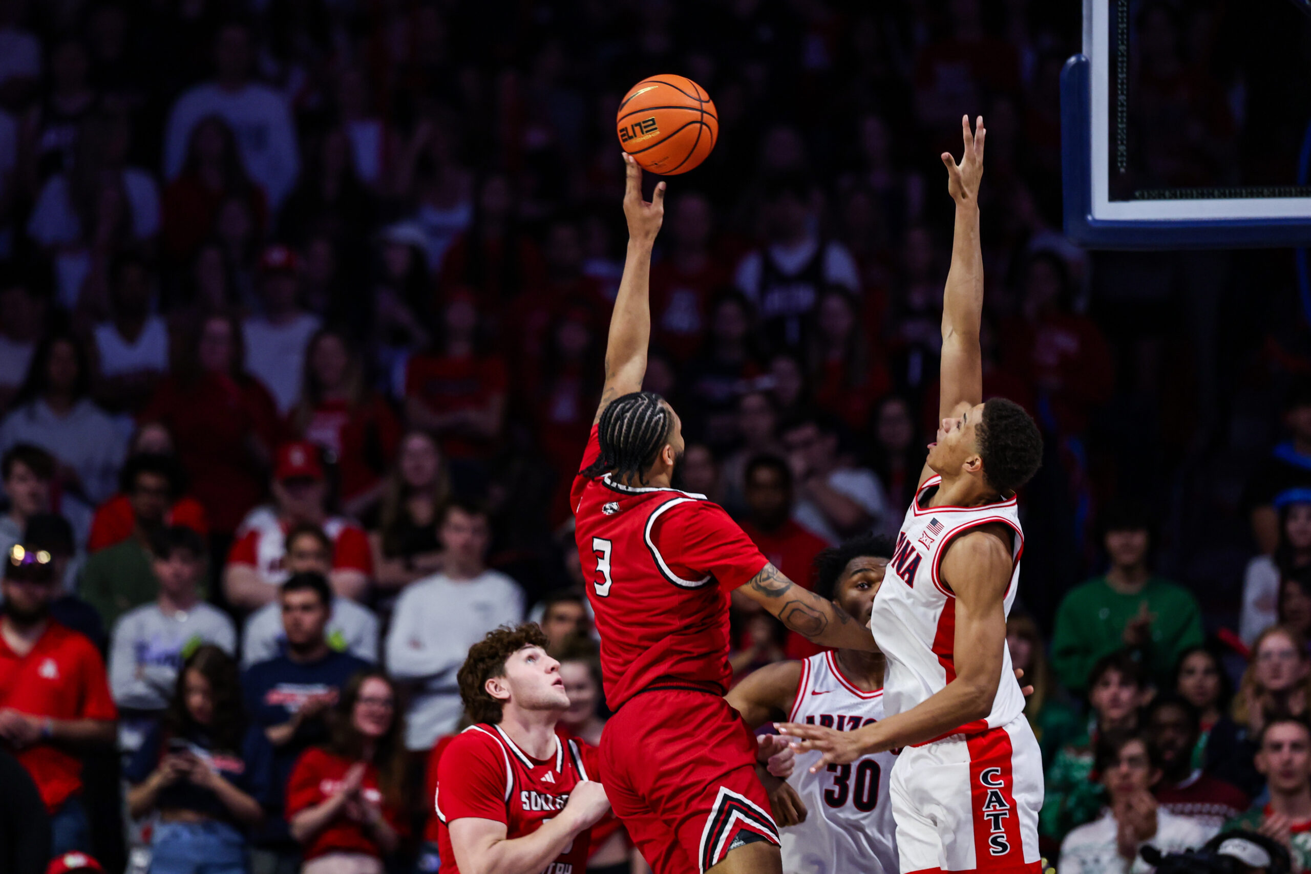 Dec 7, 2024; Tucson, Arizona, USA; Southern Utah Thunderbirds Jamir Simpson (3) shoots the ball while Arizona Wildcats guard Carter Bryant (9) attempts to block him during the second half at McKale Center. Mandatory Credit: Aryanna Frank-Imagn Images