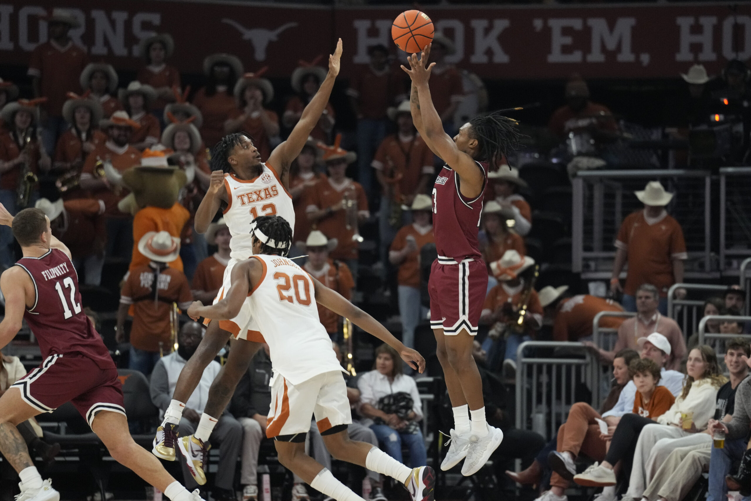 Dec 12, 2024; Austin, Texas, USA; nm New Mexico State Aggies guard Jaden Harris (13) shoots over Texas Longhorns guard Tramon Mark (12) during the second half at Moody Center. Mandatory Credit: Scott Wachter-Imagn Images