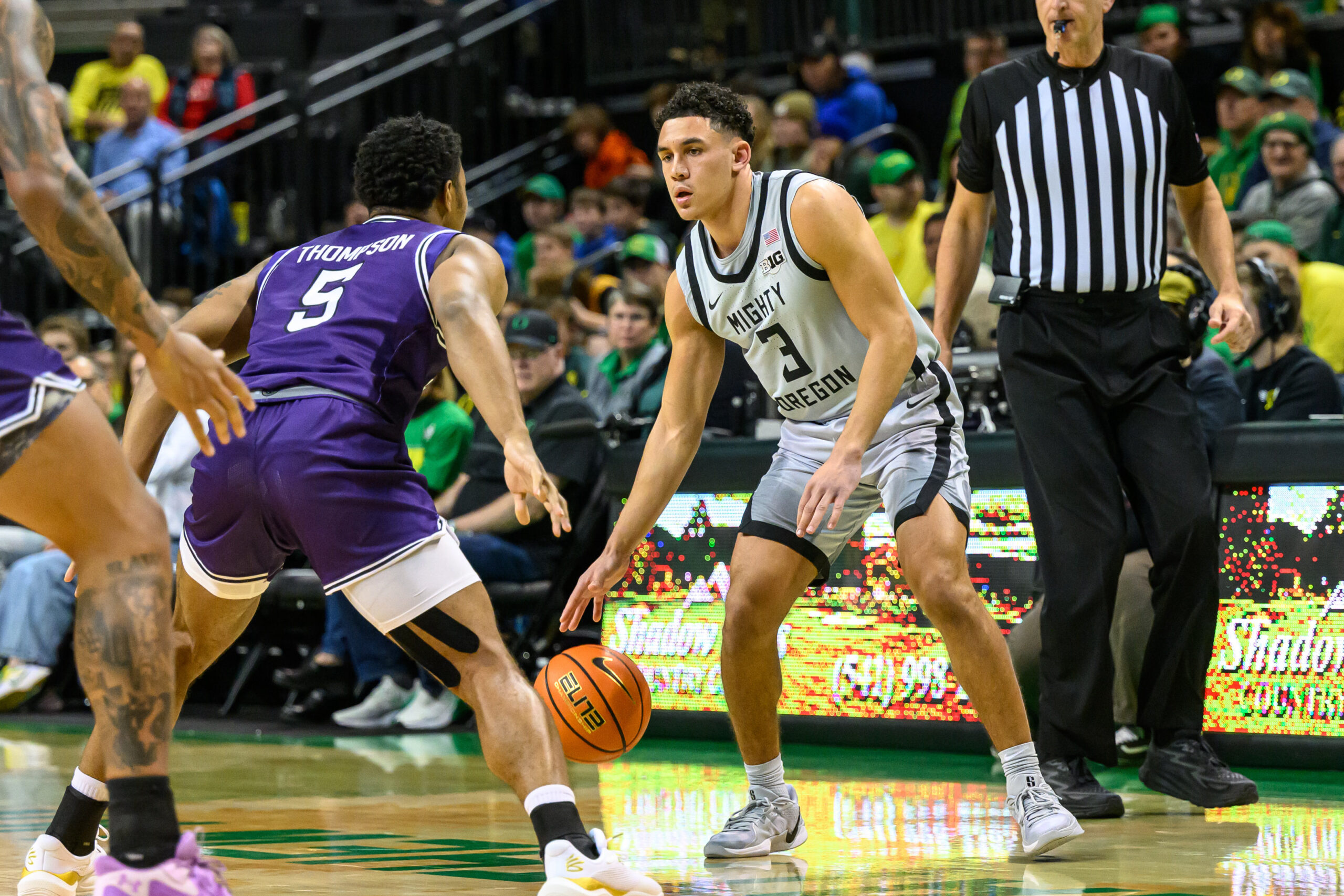 Dec 15, 2024; Eugene, Oregon, USA; Oregon Ducks guard Jackson Shelstad (3) dribbles the ball against Stephen F. Austin Lumberjacks guard Keon Thompson (5) during the first half at Matthew Knight Arena. Mandatory Credit: Craig Strobeck-Imagn Images