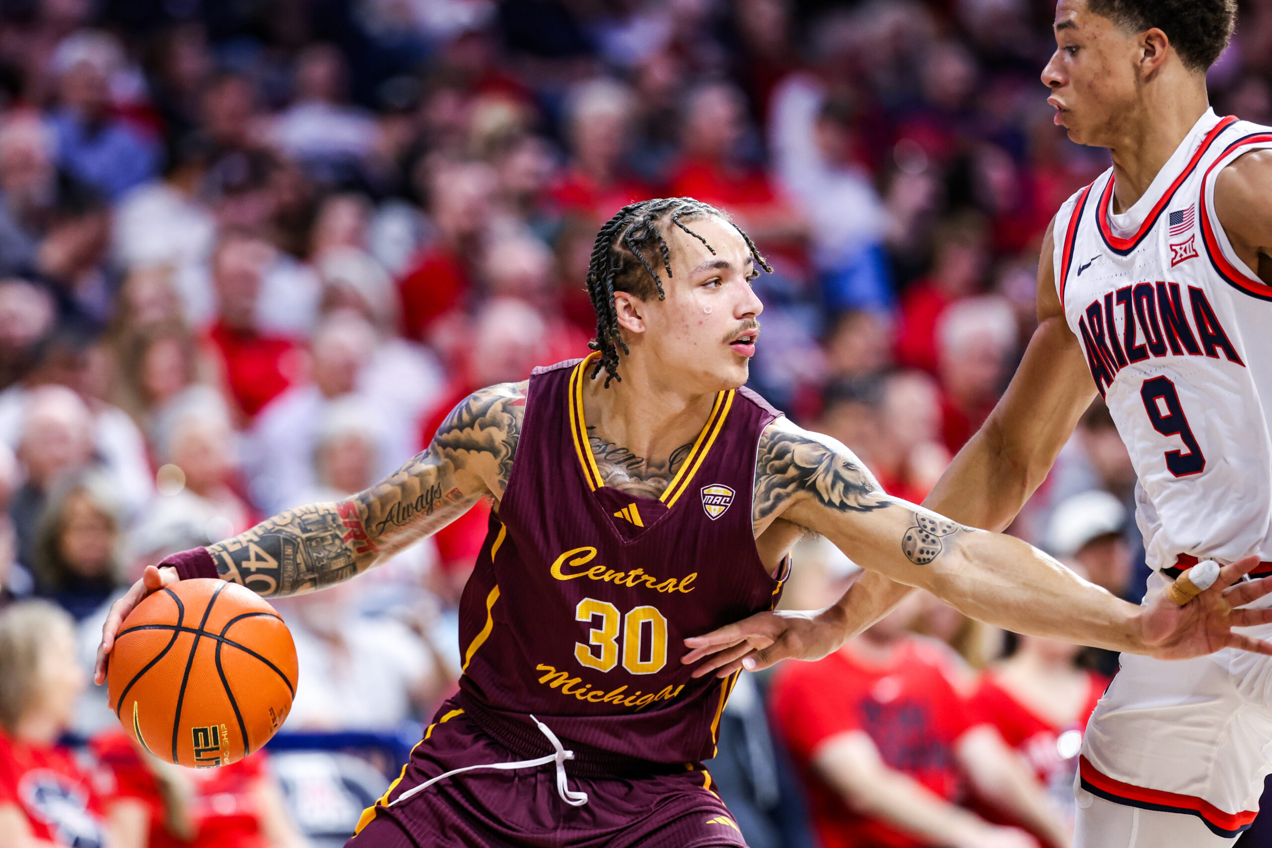 Dec 21, 2024; Tucson, Arizona, USA; Central Michigan Chippewas guard Anthony Pritchard (30) dribbles the ball while Arizona Wildcats forward Carter Bryant (9) attempts to block him during the second half of the game at McKale Center. Mandatory Credit: Aryanna Frank-Imagn Images