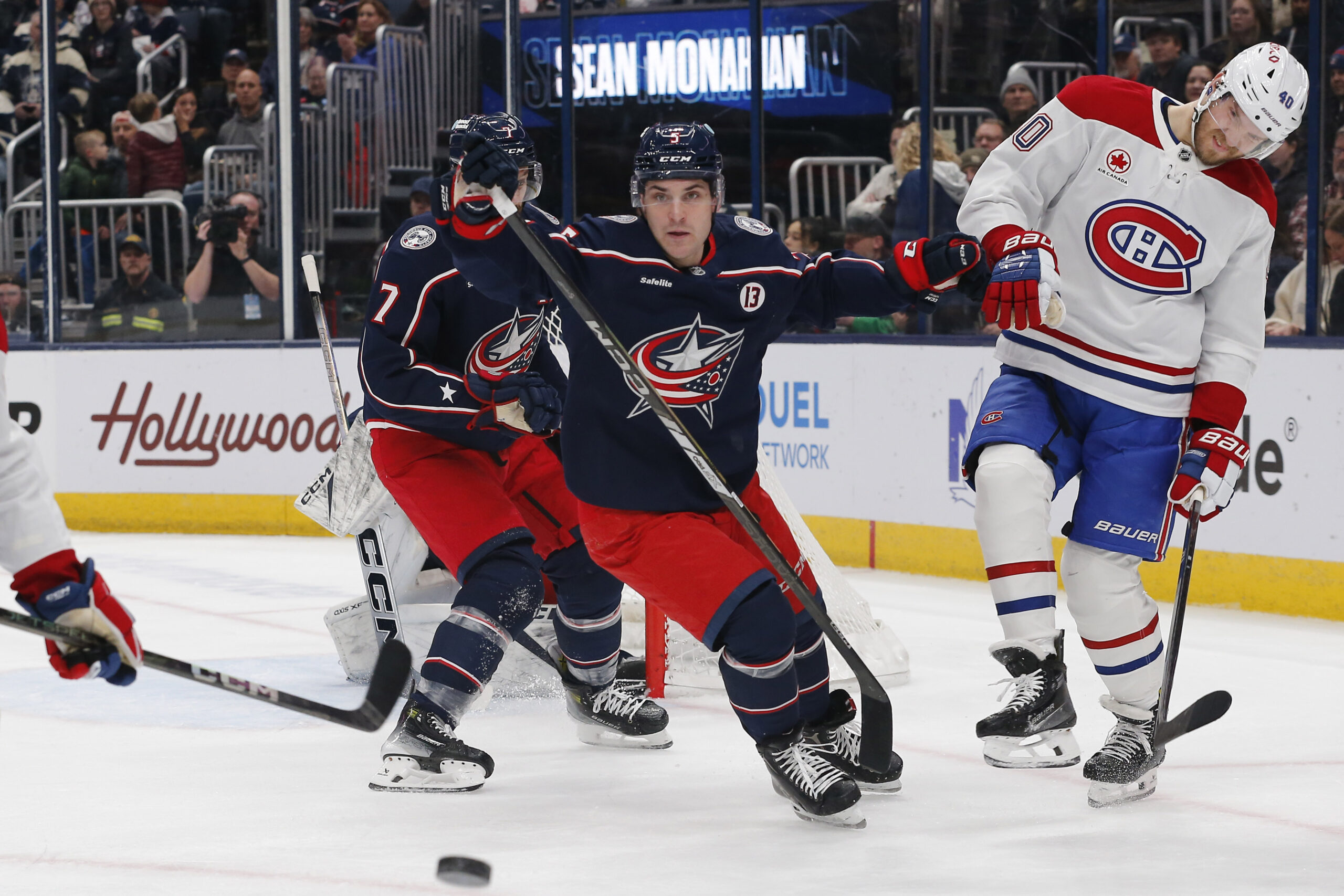 Dec 23, 2024; Columbus, Ohio, USA; Columbus Blue Jackets defenseman Denton Mateychuk (5) checks Montreal Canadiens right wing Joel Armia (40) during the first period at Nationwide Arena. Mandatory Credit: Russell LaBounty-Imagn Images