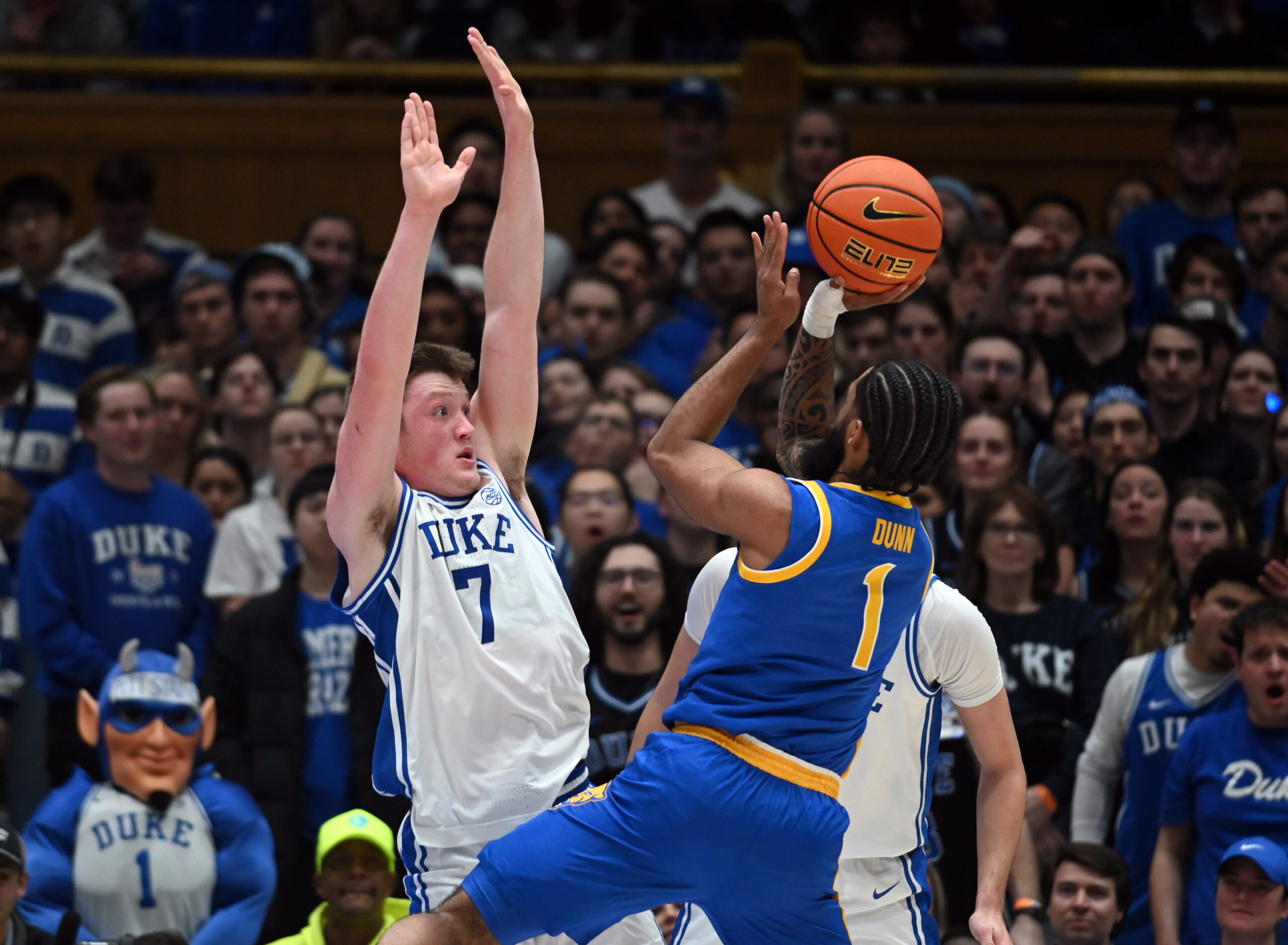 Jan 7, 2025; Durham, North Carolina, USA; Pitt Panthers guard Damian Dunn (1) shoots over Duke Blue Devils forward Kon Knueppel (7) during the second half at Cameron Indoor Stadium. Mandatory Credit: Rob Kinnan-Imagn Images