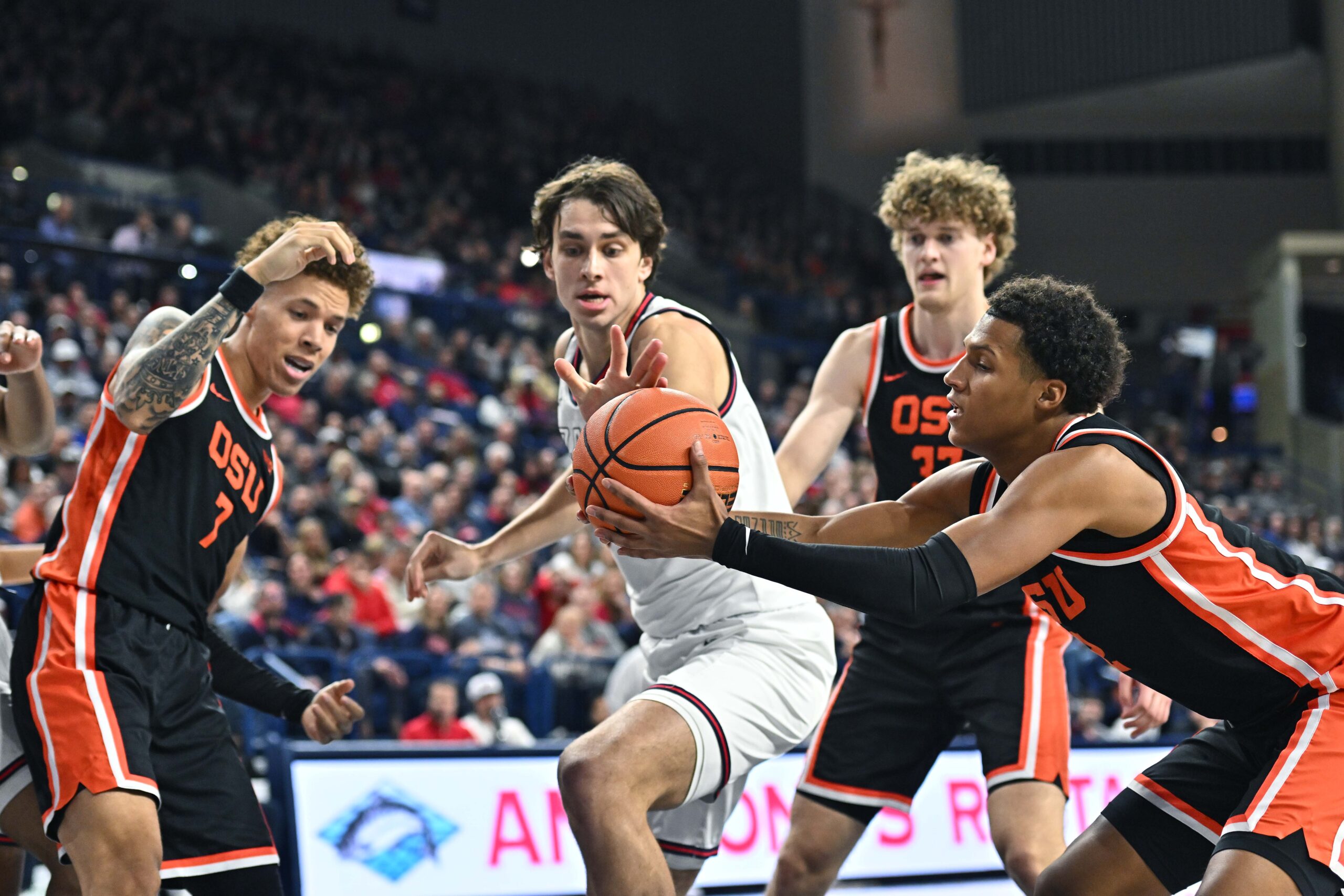 Jan 28, 2025; Spokane, Washington, USA; Oregon State Beavers guard Josiah Lake II (2) rebounds the ball against Gonzaga Bulldogs forward Braden Huff (34) in the second half at McCarthey Athletic Center. Mandatory Credit: James Snook-Imagn Images