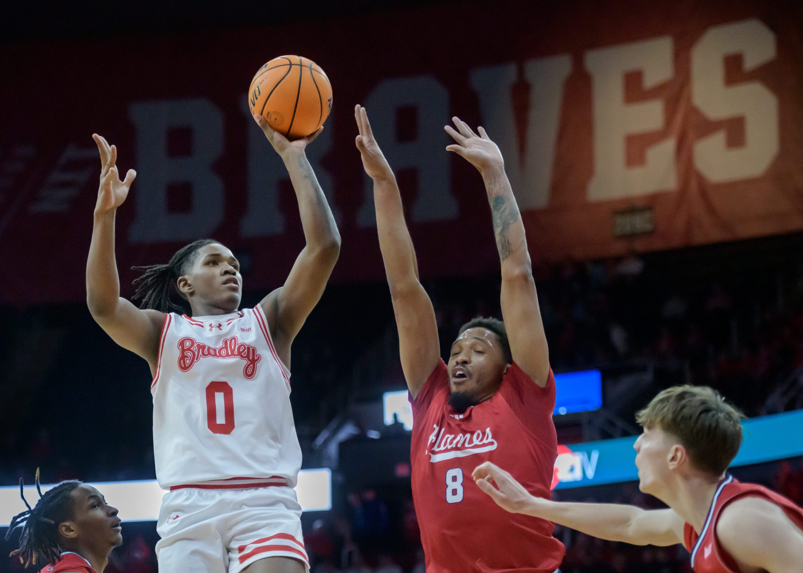 Bradley’s Demarion Burch (0) shoots over the UIC defense in the second half of their MVC basketball game Wednesday, Jan. 29, 2025 at Carver Arena in Peoria. The Braves fell 93-70 to the Flames.