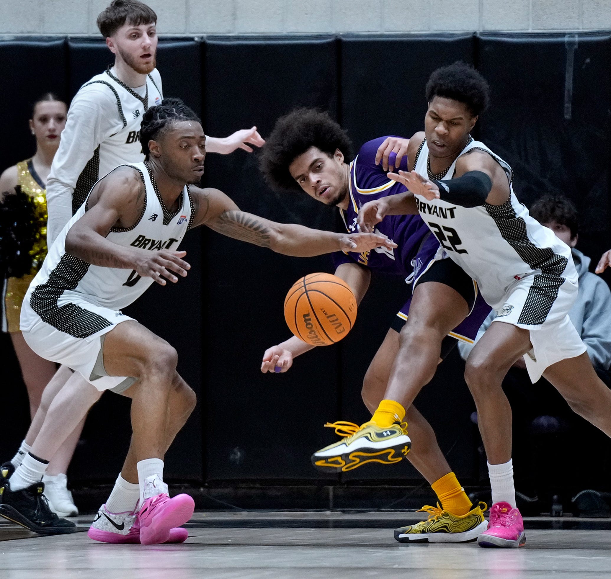 L to ri Bryant Bulldogs Connor Withers, Earl Timberlake and Keyshawn Mitchell try to beat Great Dane Justin Neely to a runaway rebound in the first half.