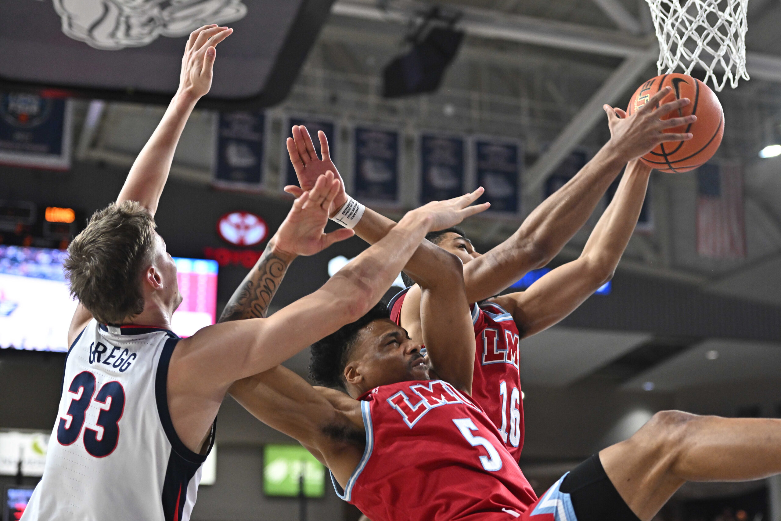 Feb 6, 2025; Spokane, Washington, USA; Loyola Marymount Lions forward Aaron McBride (16) rebounds against Gonzaga Bulldogs forward Ben Gregg (33) in the second half at McCarthey Athletic Center. Gonzaga Bulldogs won 73-53. Mandatory Credit: James Snook-Imagn Images