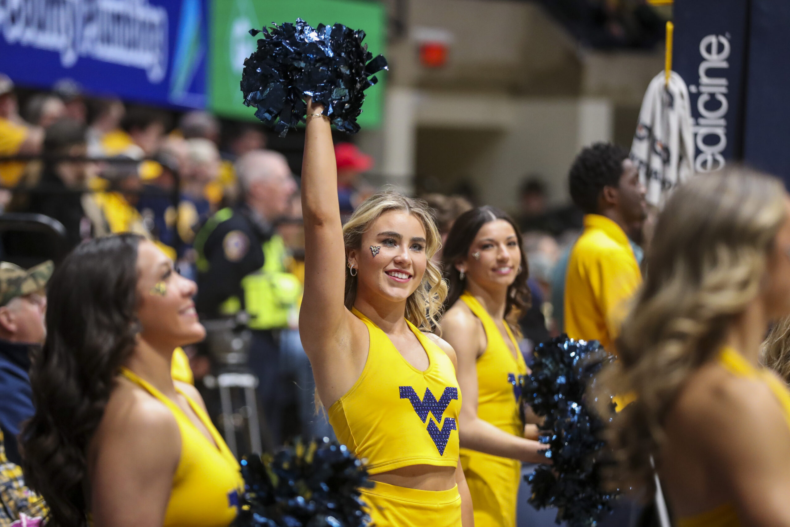 Feb 19, 2025; Morgantown, West Virginia, USA; A West Virginia Mountaineers cheerleader performs during the first half against the Cincinnati Bearcats at WVU Coliseum. Mandatory Credit: Ben Queen-Imagn Images