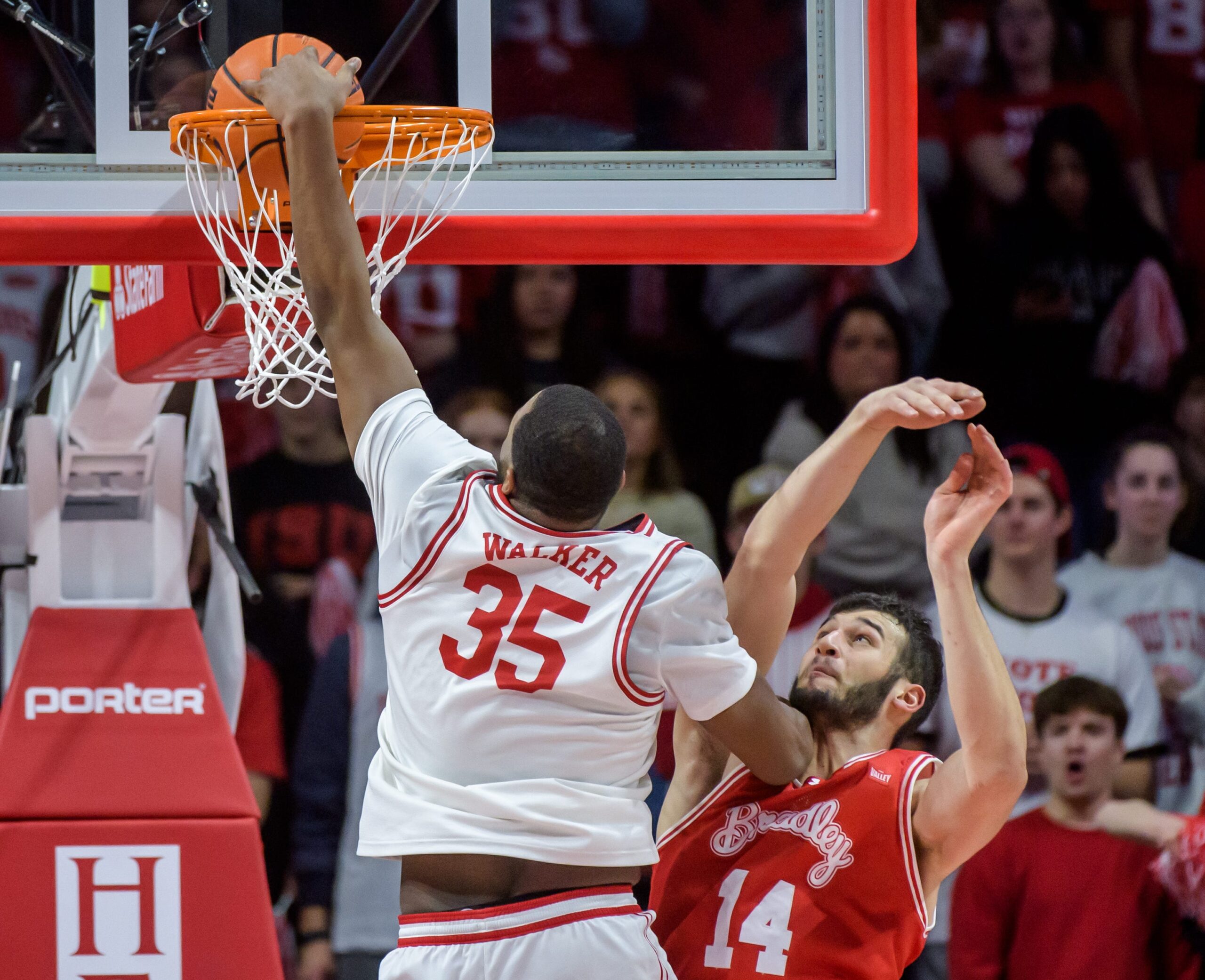 Illinois State's Charles Walker dunks over Bradley's Ahmet Jonovic in the first half of their Missouri Valley Conference basketball game Wednesday, Feb. 19, 2025 at CEFCU Arena in Normal. The Braves fell to the Redbirds 82-71.