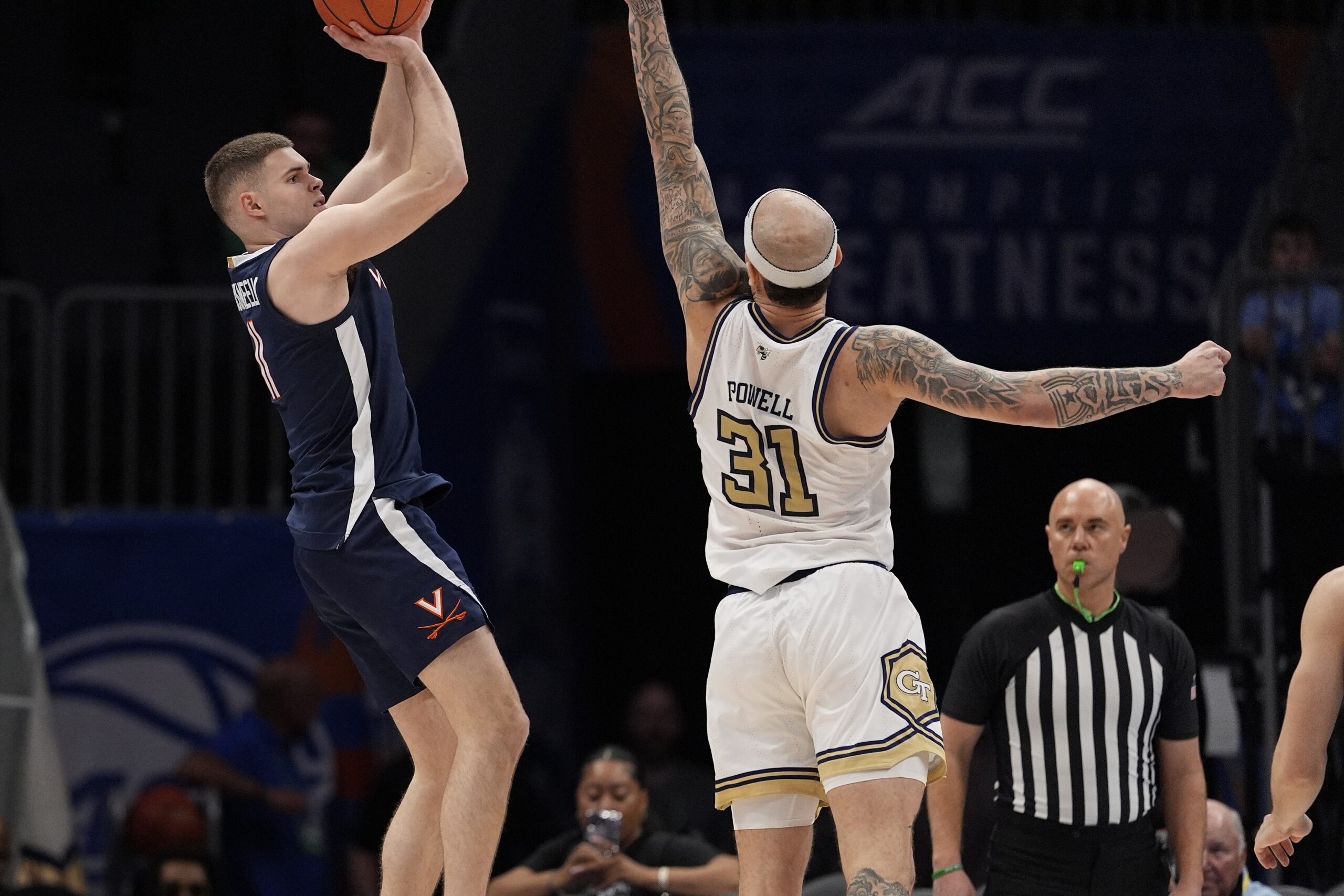 Mar 12, 2025; Charlotte, NC, USA;Virginia Cavaliers guard Isaac McKneely (11) shoots the jumper over Georgia Tech Yellow Jackets forward Duncan Powell (31) during the second half at Spectrum Center. Mandatory Credit: Jim Dedmon-Imagn Images